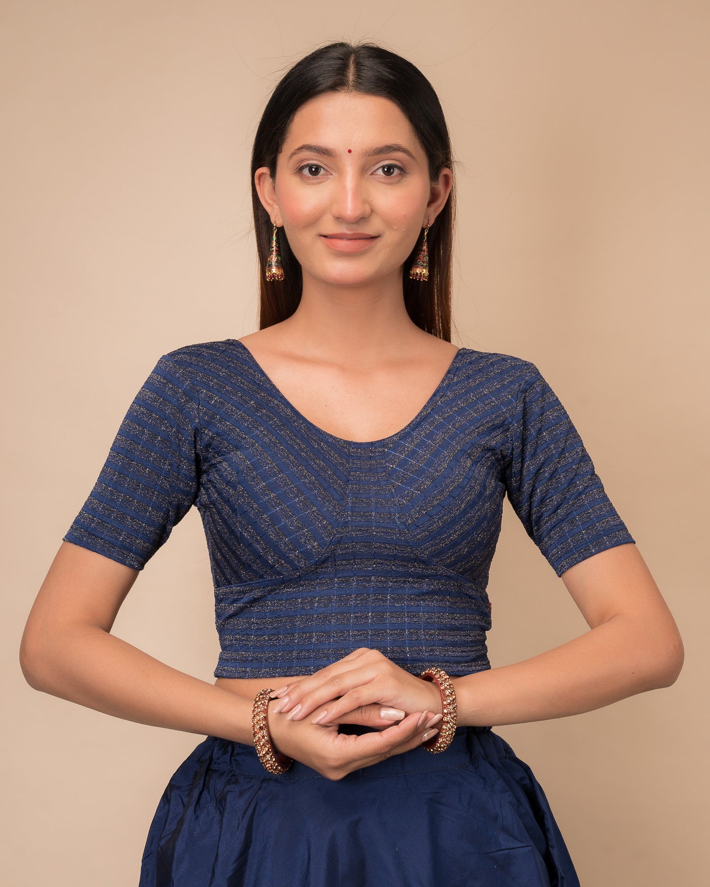 Model wearing a zari stripe stretchable readymade blouse with elbow sleeves and round neckline
