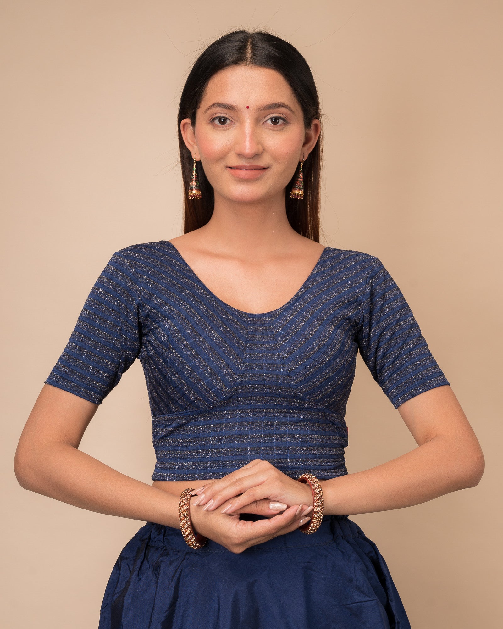Model wearing a zari stripe stretchable readymade blouse with elbow sleeves and round neckline