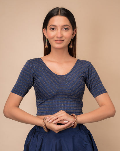Model wearing a zari stripe stretchable readymade blouse with elbow sleeves and round neckline