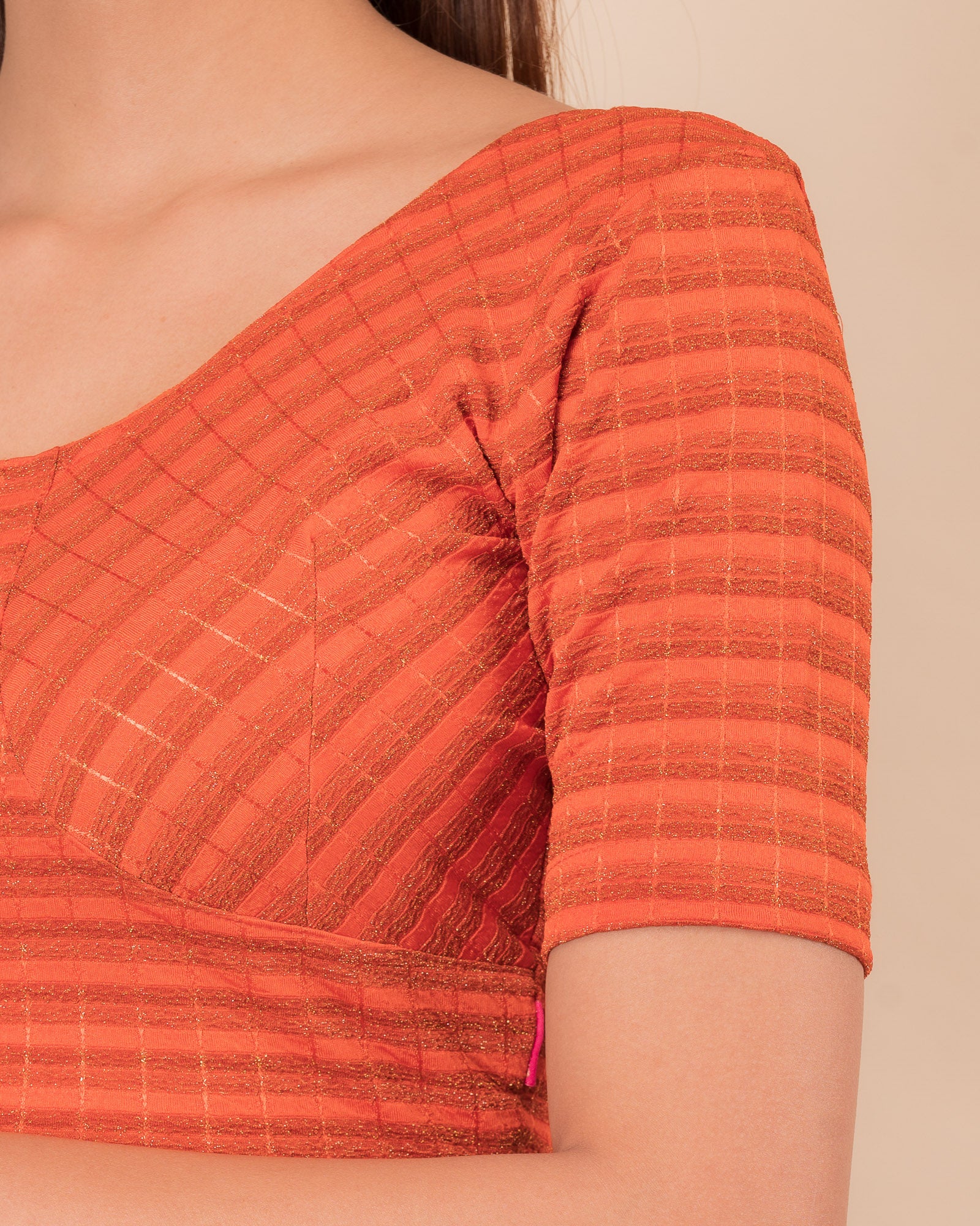 Close-up of the zari stripe fabric detailing the texture and stretchability of the readymade blouse