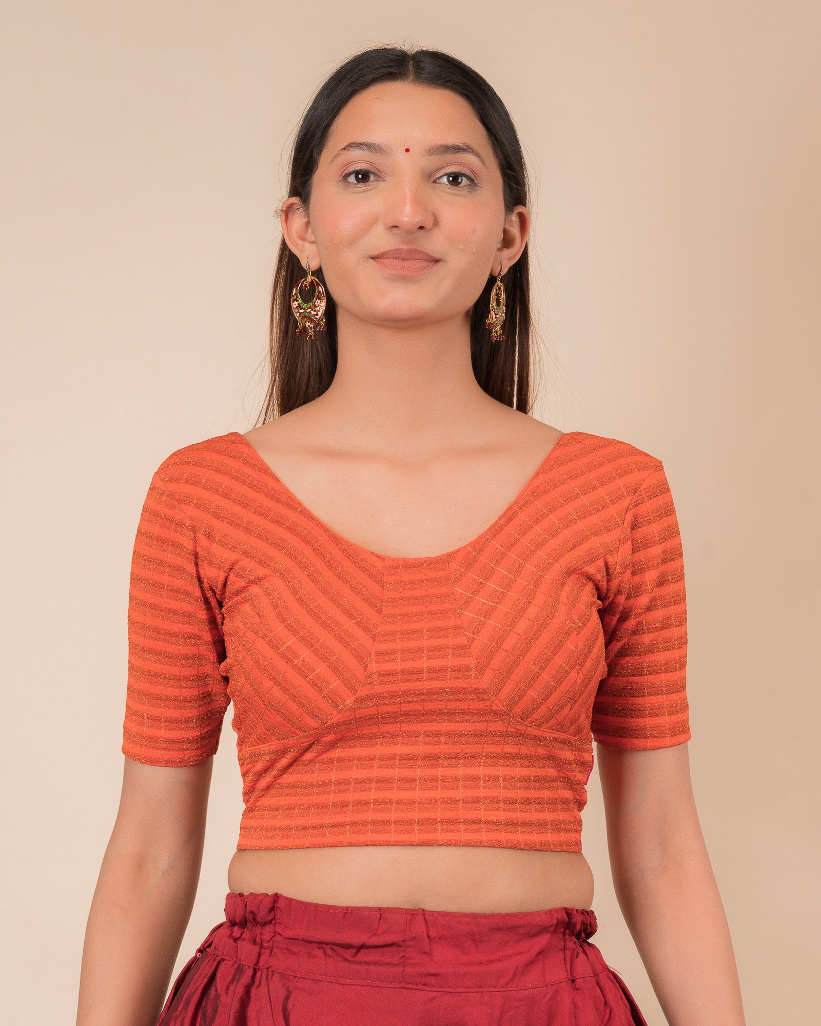  Model wearing a zari stripe stretchable readymade blouse with elbow sleeves and round neckline