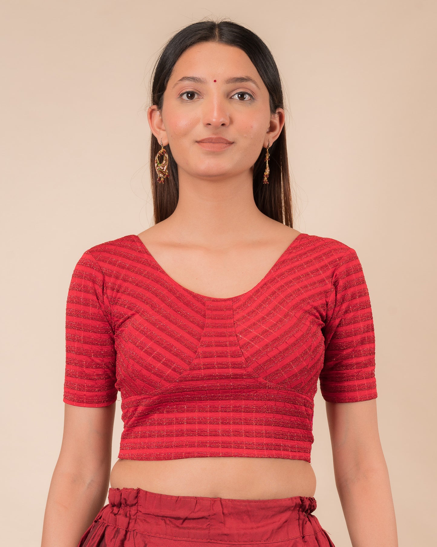 Model wearing a zari stripe stretchable readymade blouse with elbow sleeves and round neckline