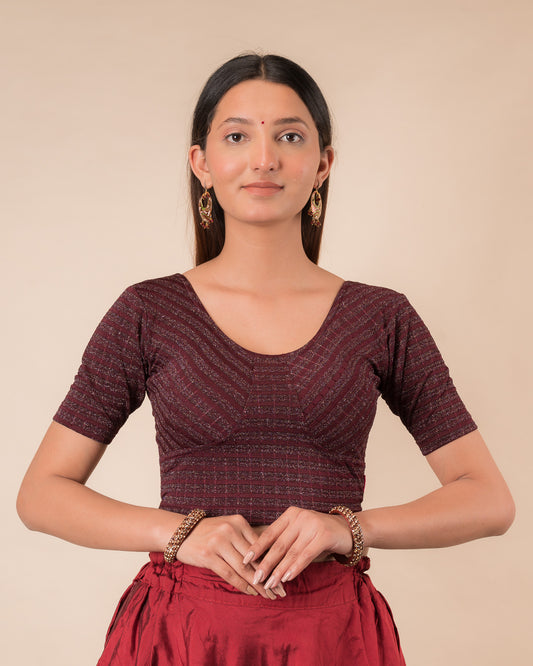 Model wearing a zari stripe stretchable readymade blouse with elbow sleeves and round neckline