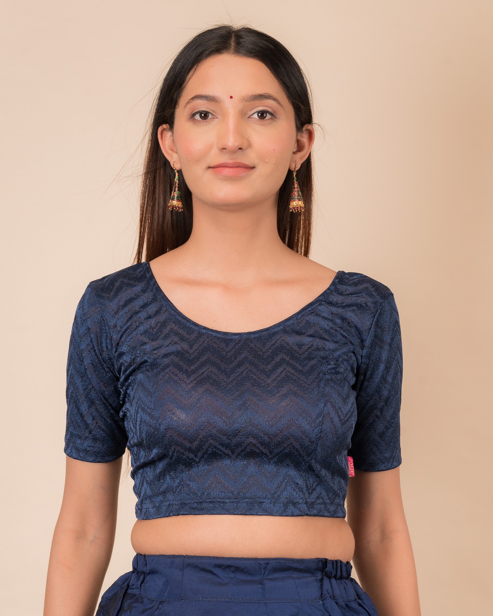 Model wearing a maroon melange zig-zag patterned stretchable readymade blouse with elbow sleeves and round neckline