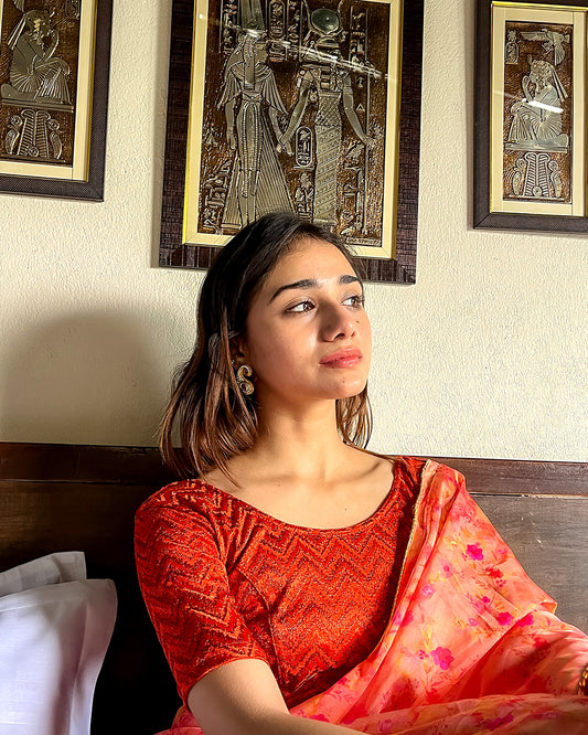 Model pairing the maroon melange zig-zag blouse with a traditional saree, demonstrating a complete ethnic look