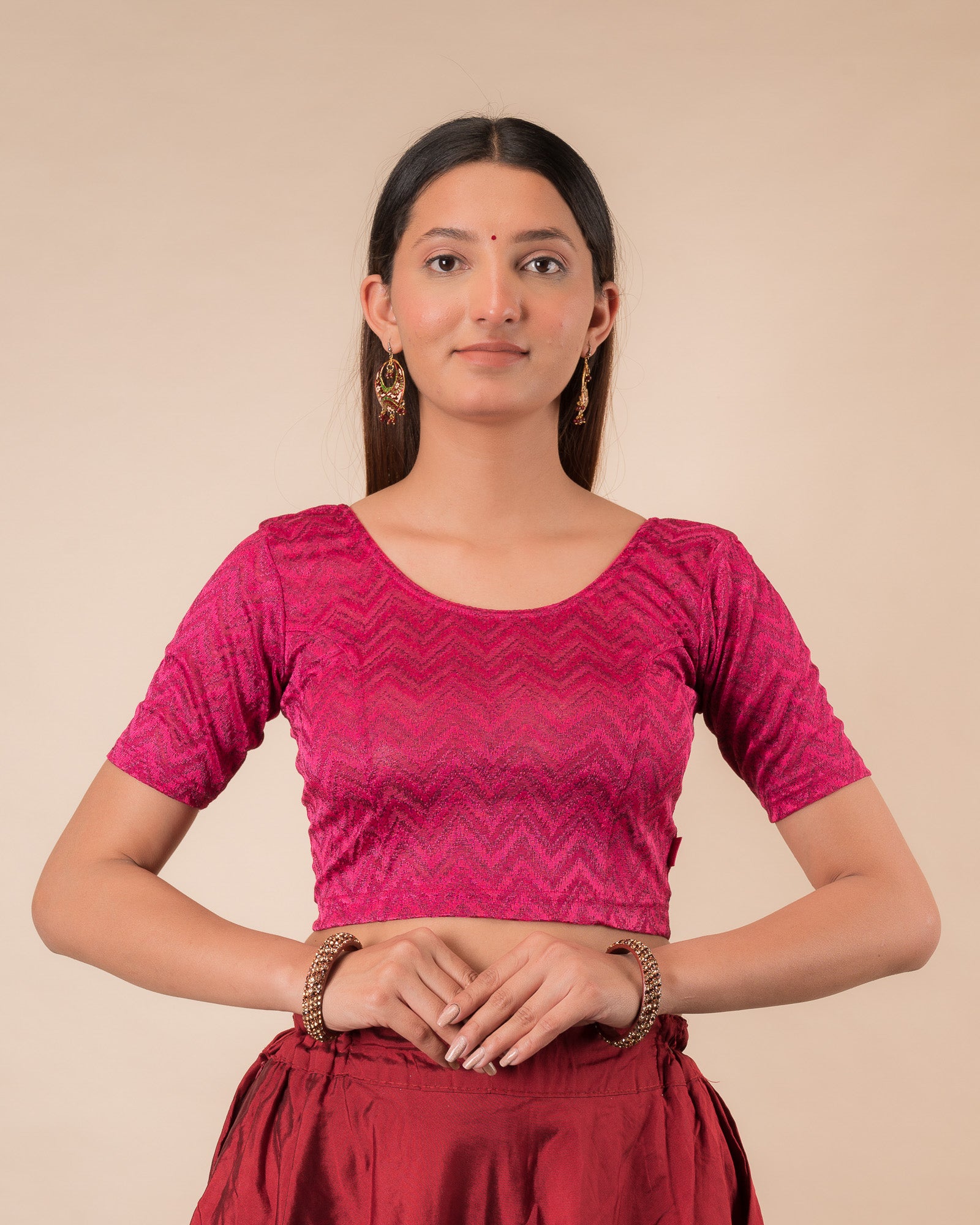 Model wearing a maroon melange zig-zag patterned stretchable readymade blouse with elbow sleeves and round neckline