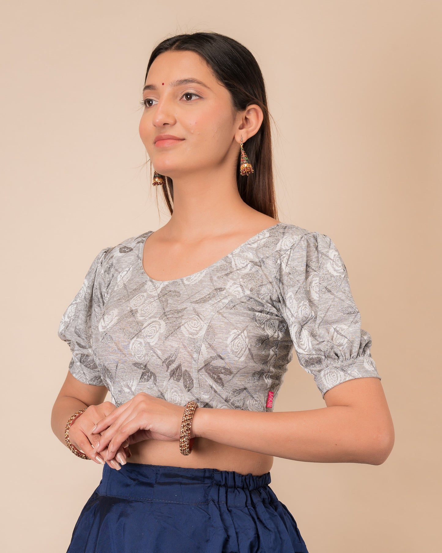 Side profile of the grey melange stretchable blouse highlighting the fit and sleeve length