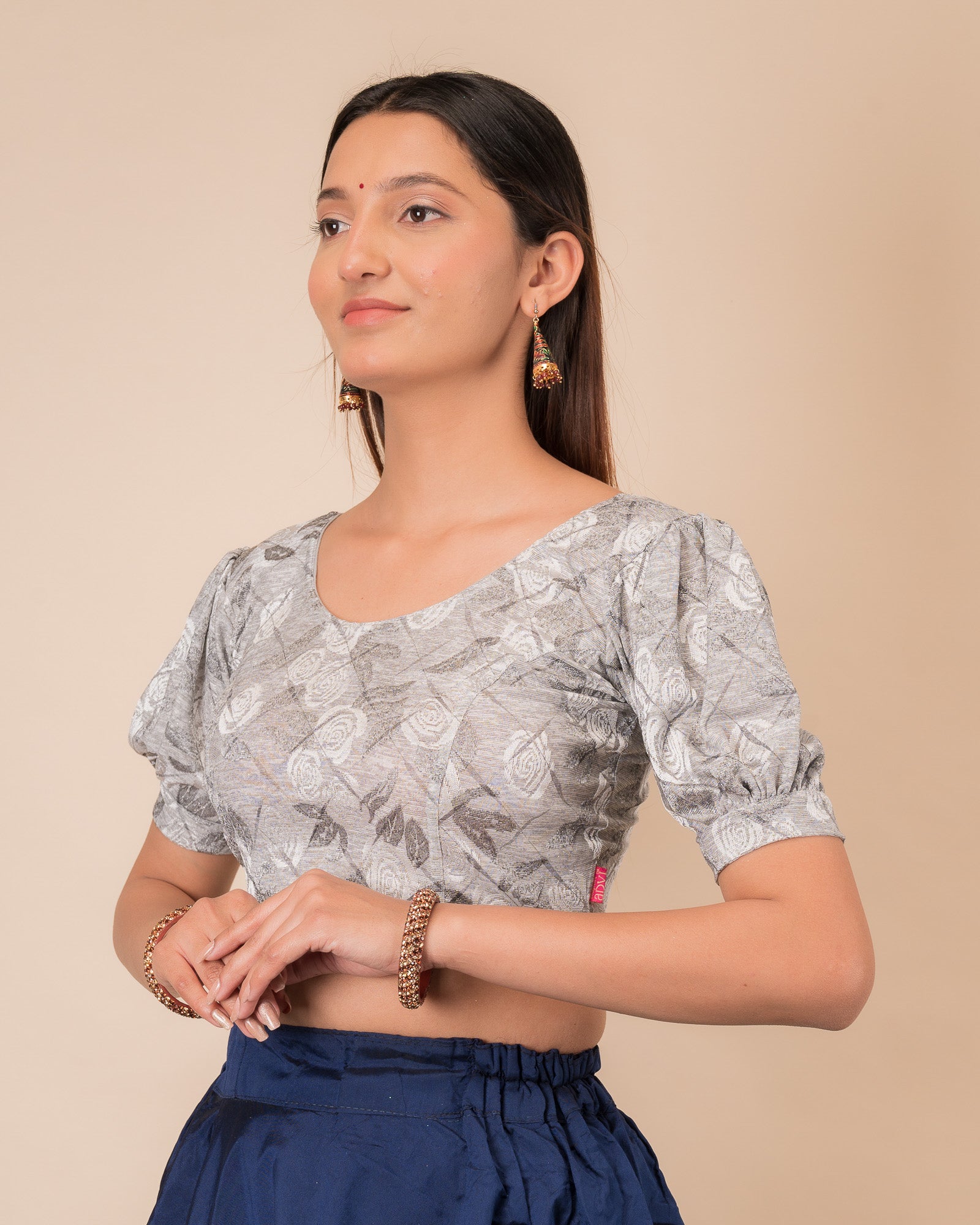 Side profile of the grey melange stretchable blouse highlighting the fit and sleeve length