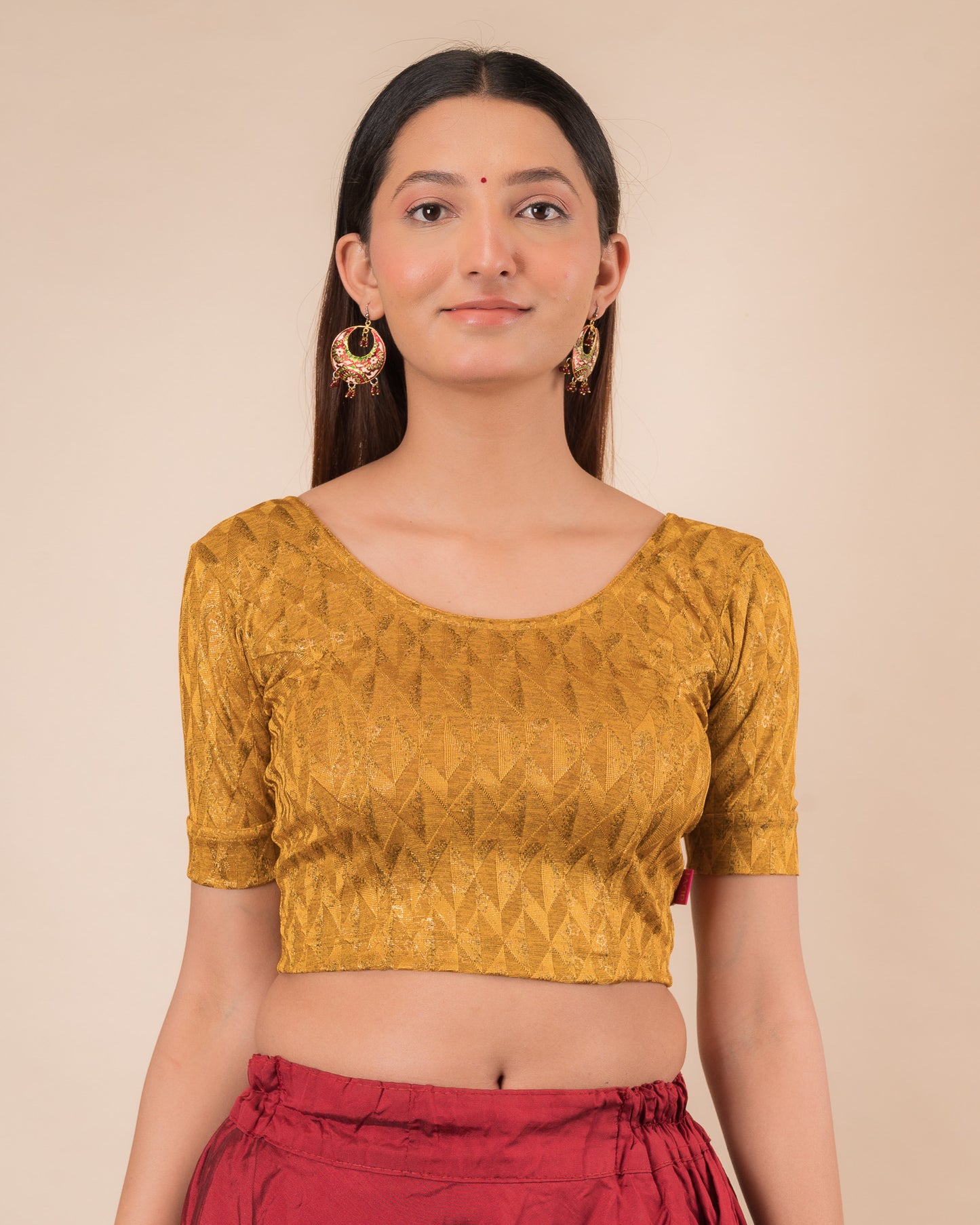 Model wearing a floral foil stretchable blouse with elbow sleeves, round neckline, and ruffle detail