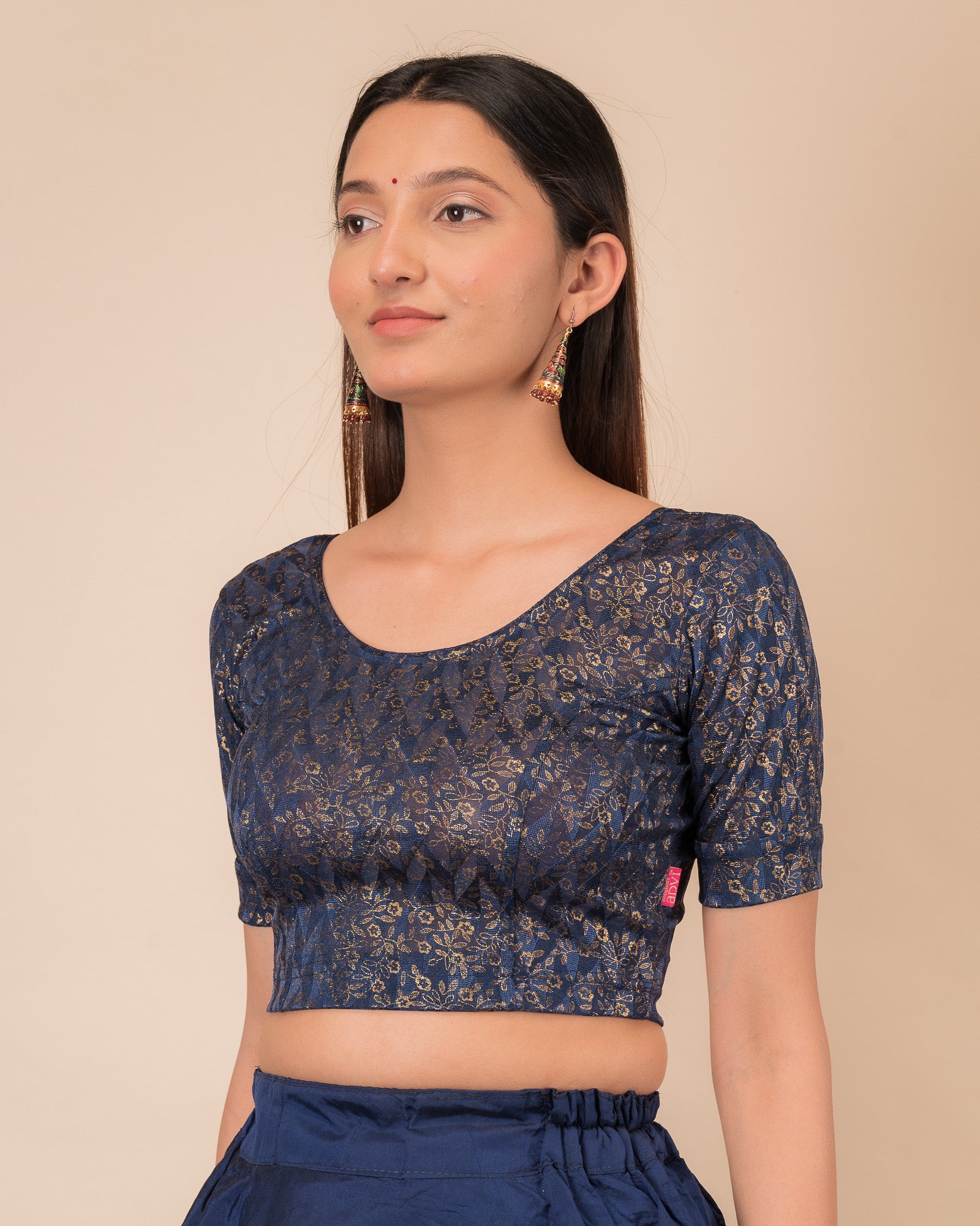 Highlighting the fit, sleeve length, and ruffle detail from the side