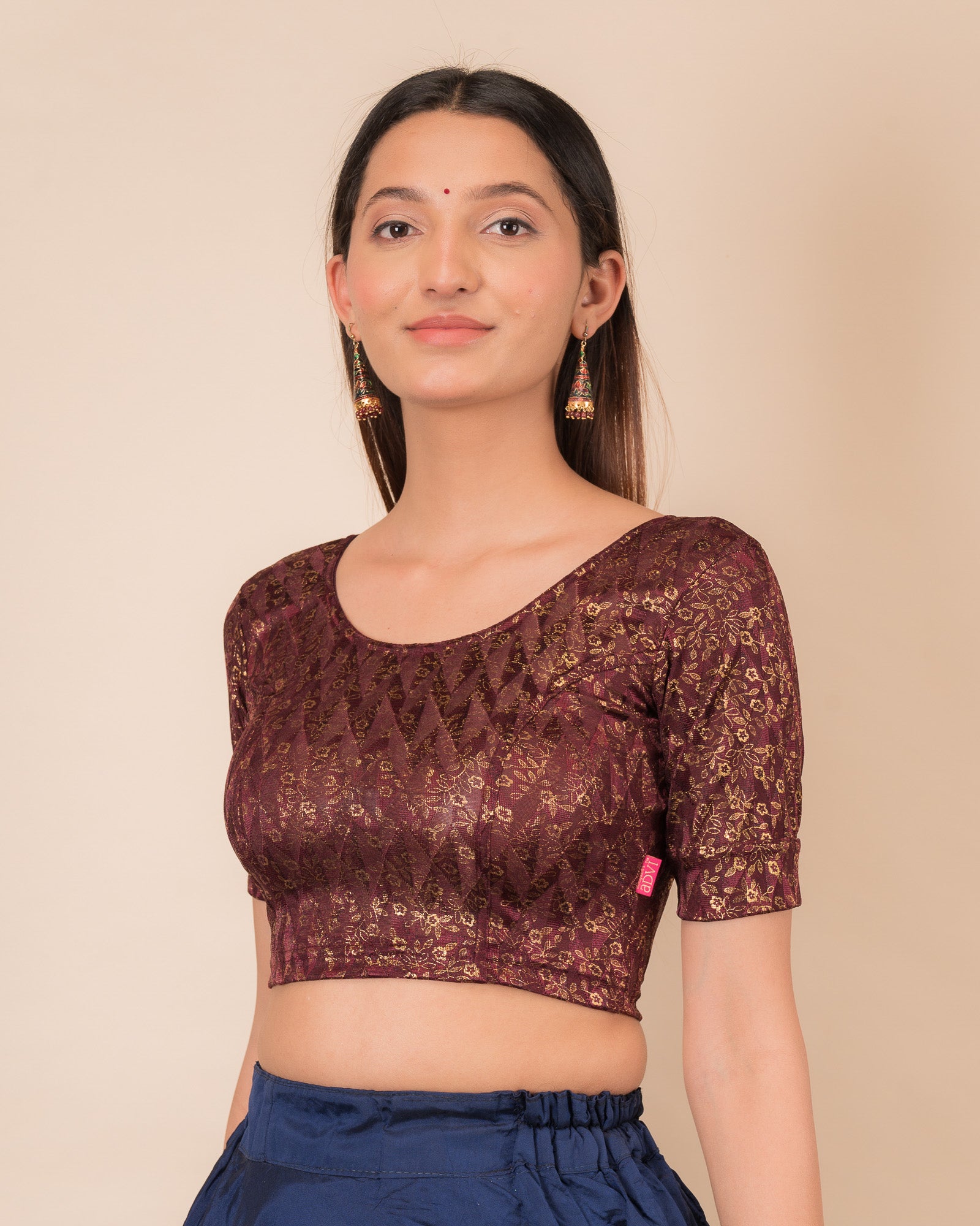 Highlighting the fit, sleeve length, and ruffle detail from the side