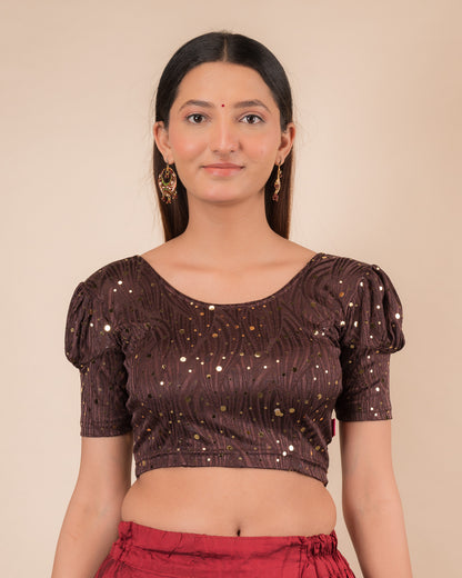 Model wearing a red stretchable blouse with gold mirror embellishments, puff sleeves, and round neckline