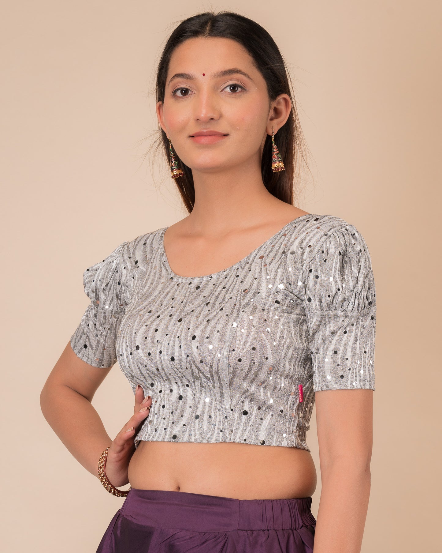 Side profile highlighting the fit and puffed sleeve silhouette
