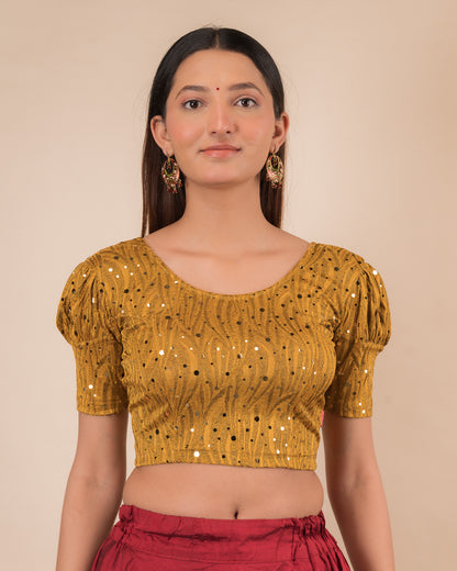  Model wearing a red stretchable blouse with gold mirror embellishments, puff sleeves, and round neckline