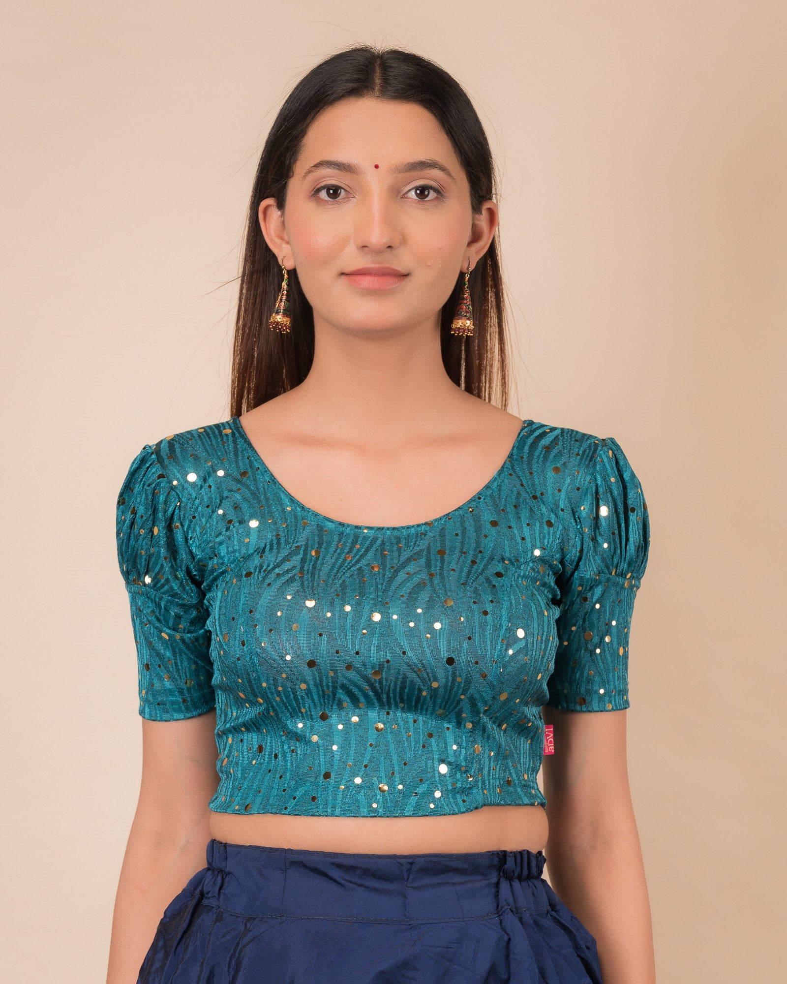  Model wearing a red stretchable blouse with gold mirror embellishments, puff sleeves, and round neckline