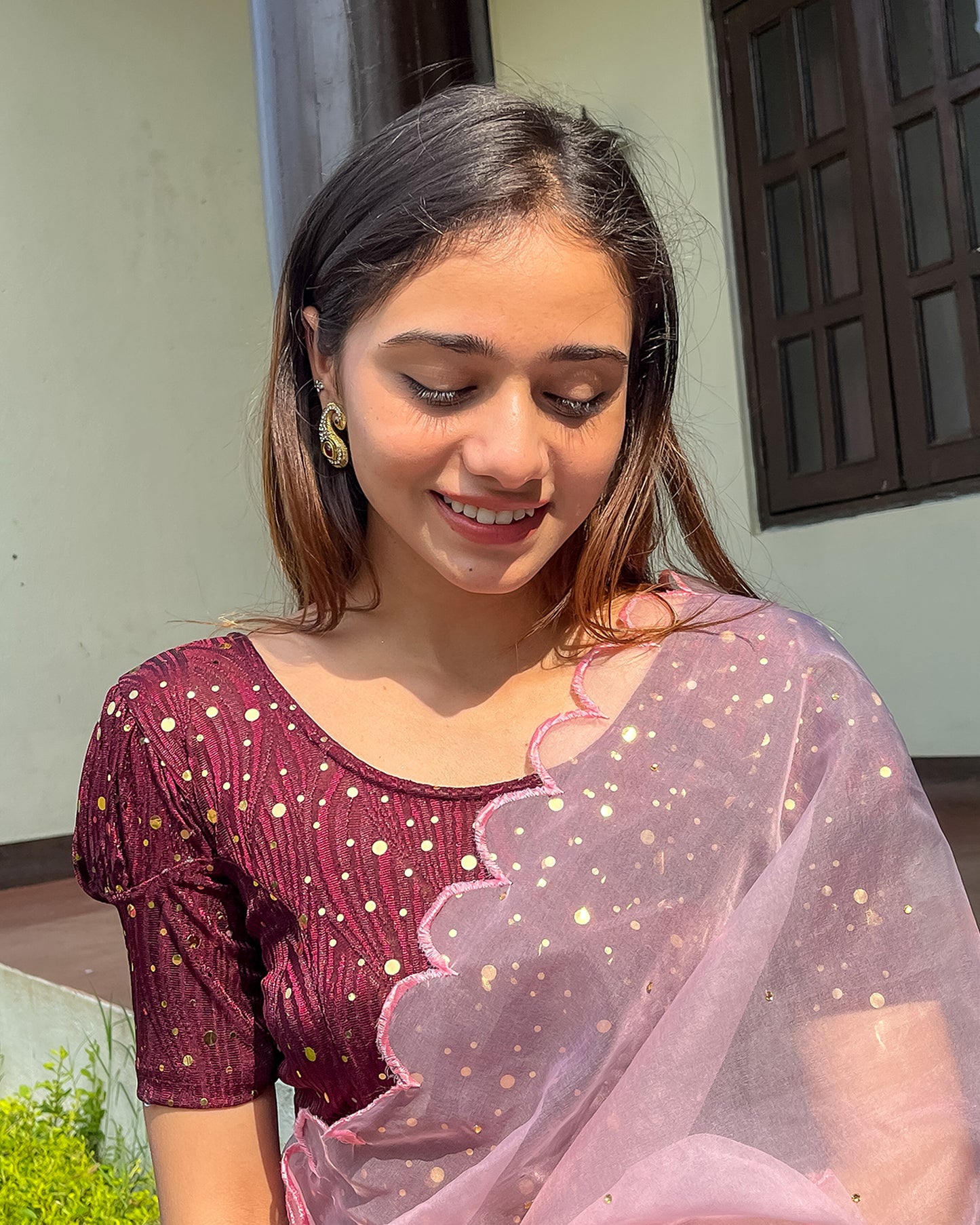 Model pairing the blouse with a saree for a festive occasion