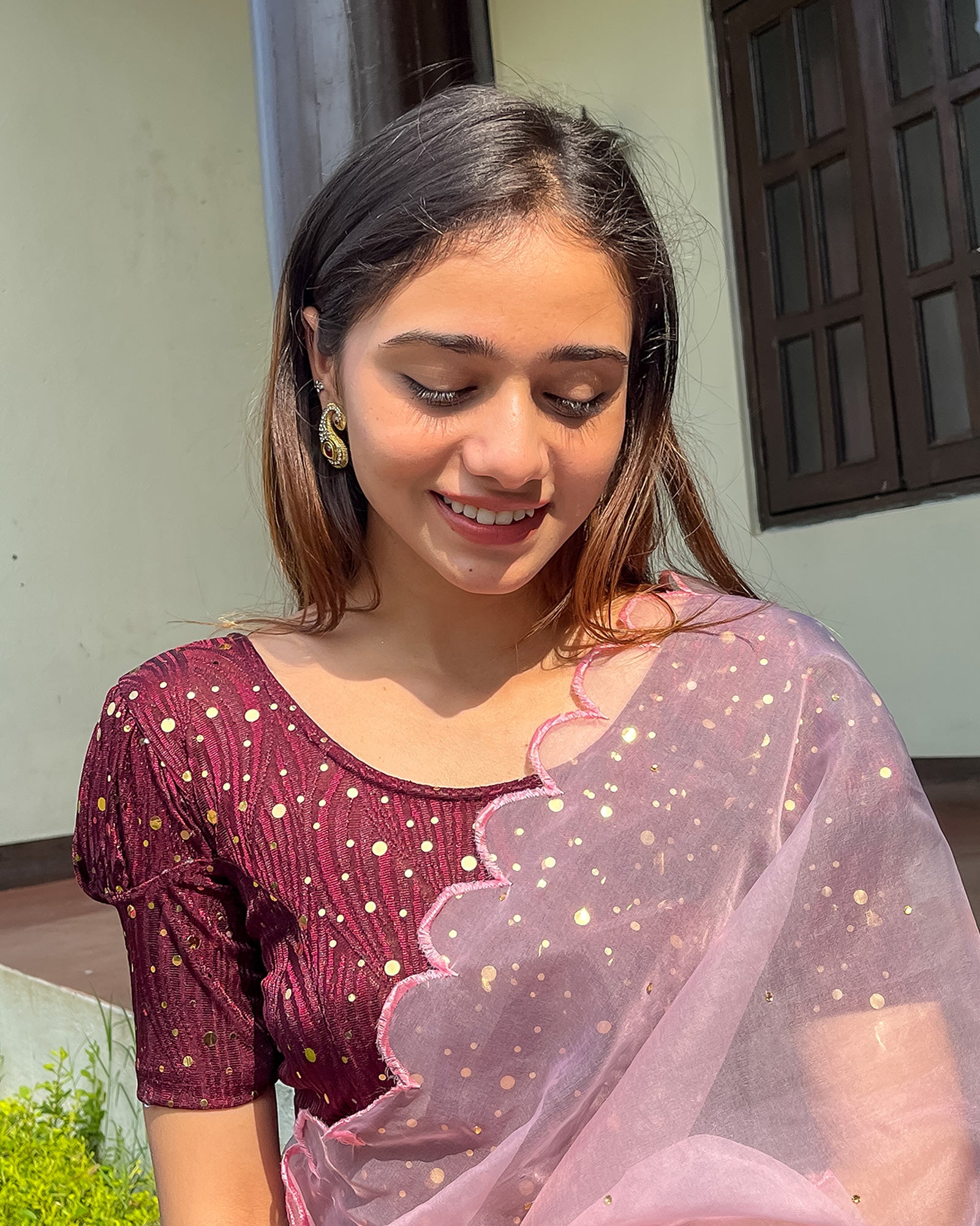 Model pairing the blouse with a saree for a festive occasion