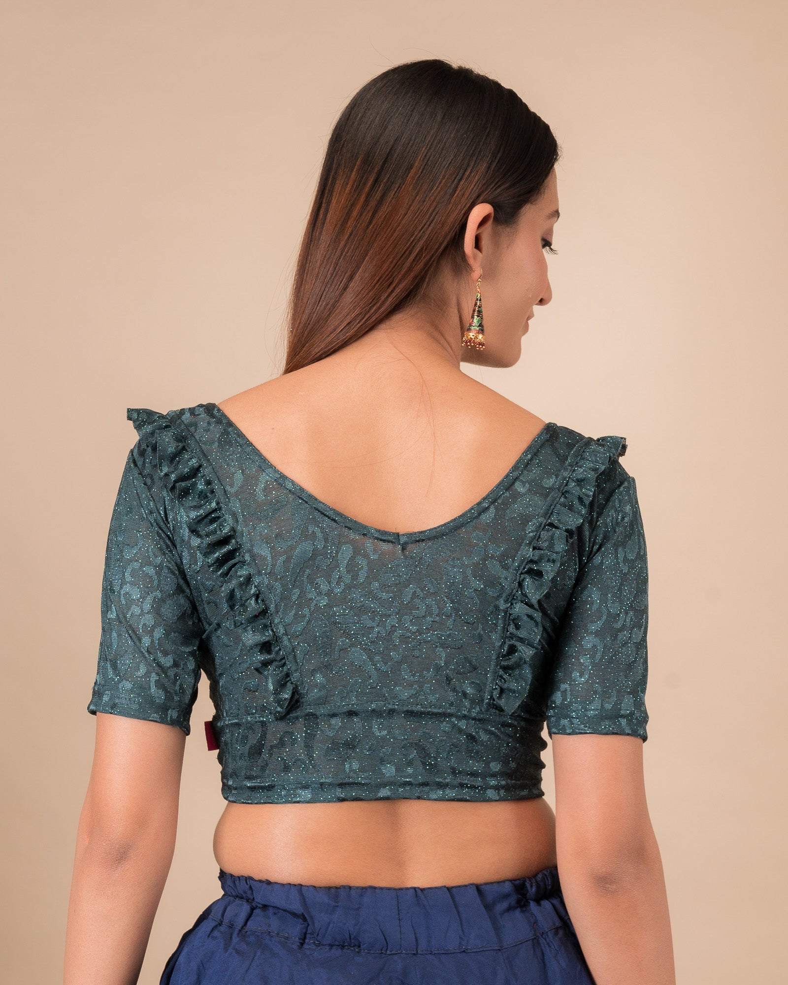 Rear view showcasing the slip-on design and ruffled shoulder detail