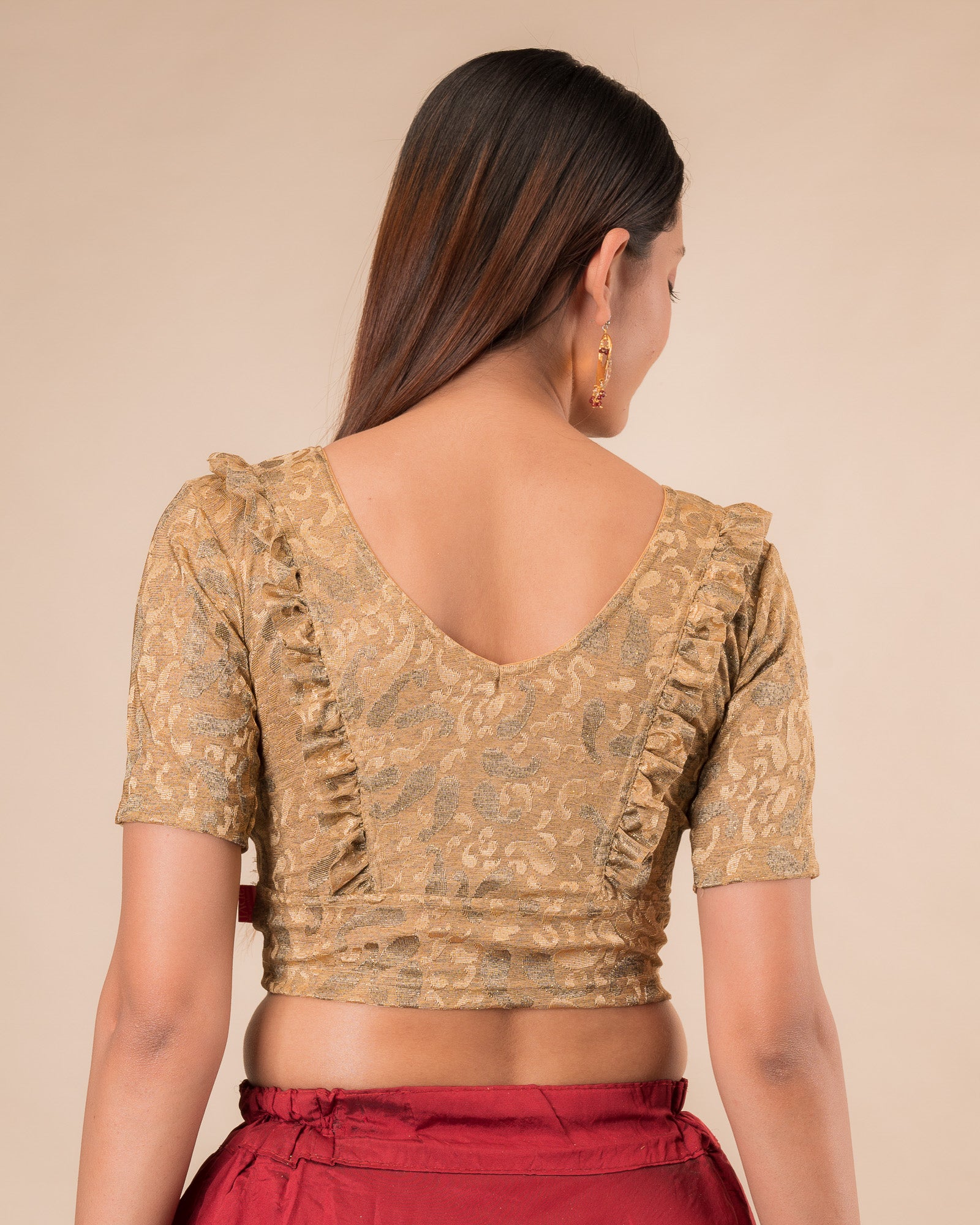 Rear view showcasing the slip-on design and ruffled shoulder detail