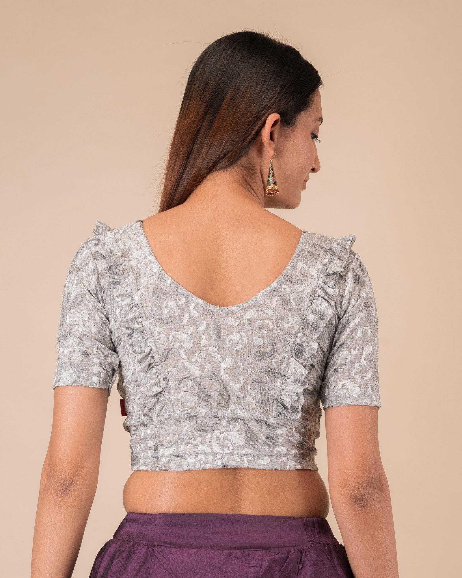 Rear view showcasing the slip-on design and ruffled shoulder detail