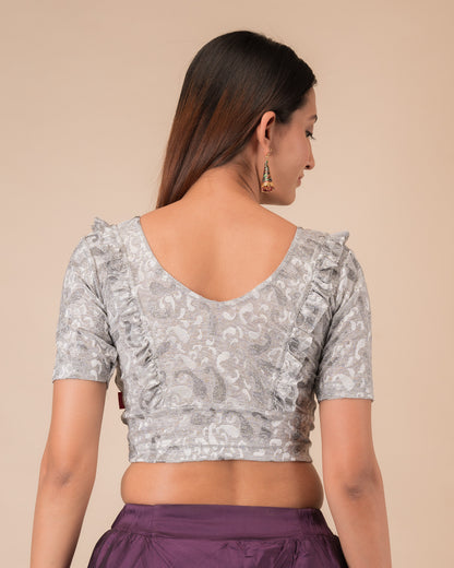 Rear view showcasing the slip-on design and ruffled shoulder detail