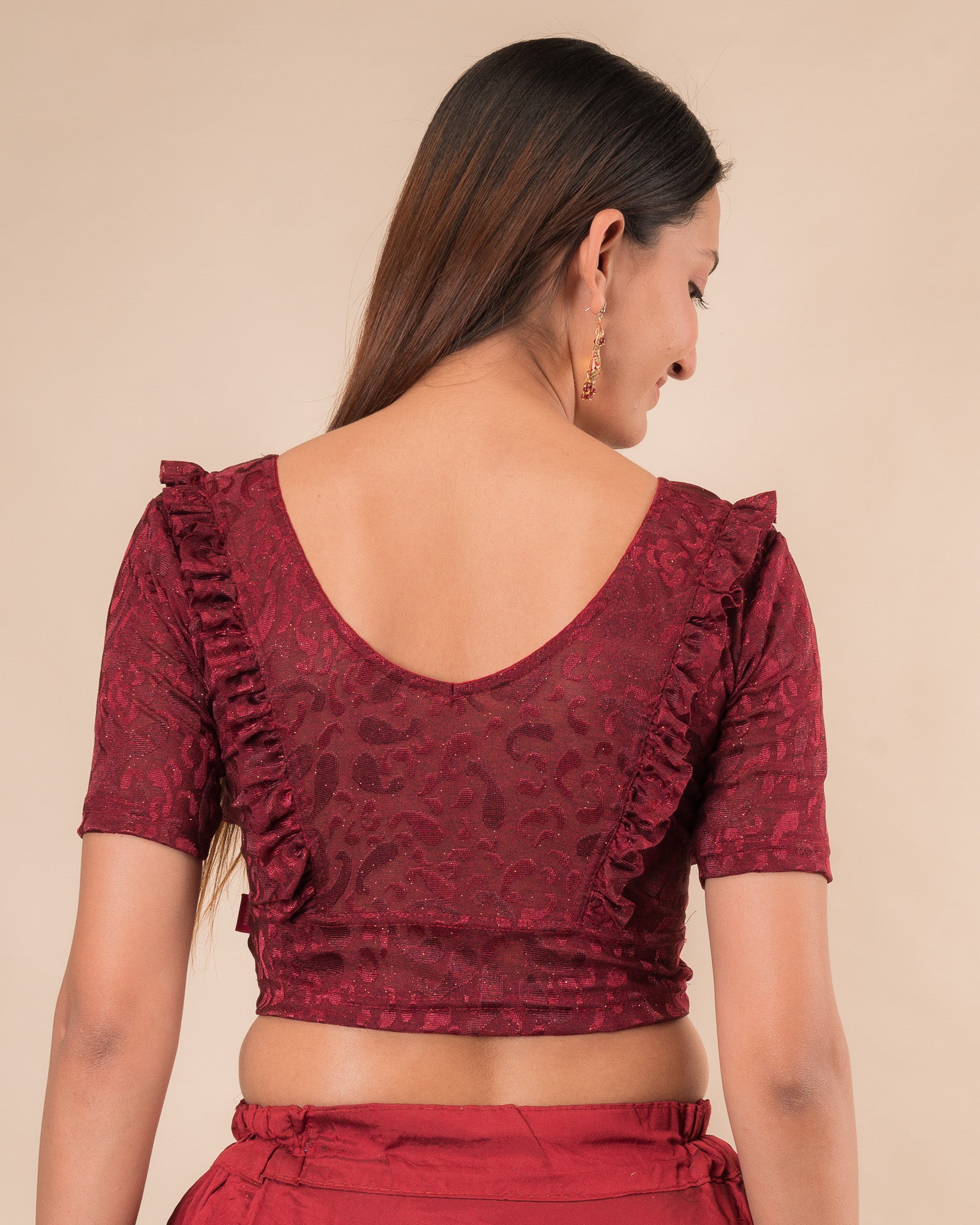 Rear view showcasing the slip-on design and ruffled shoulder detail