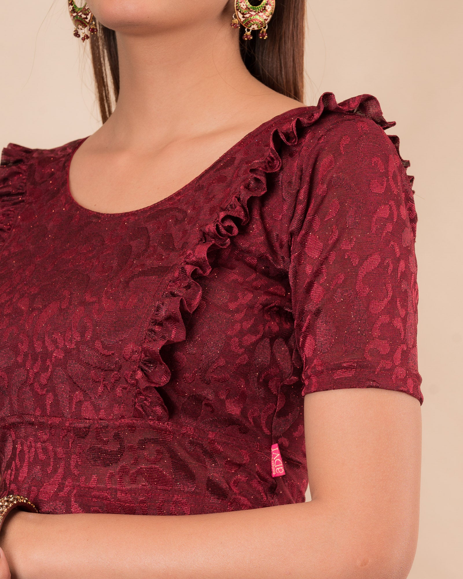 Close-up of the melange jacquard knit with subtle glitter and paisley pattern