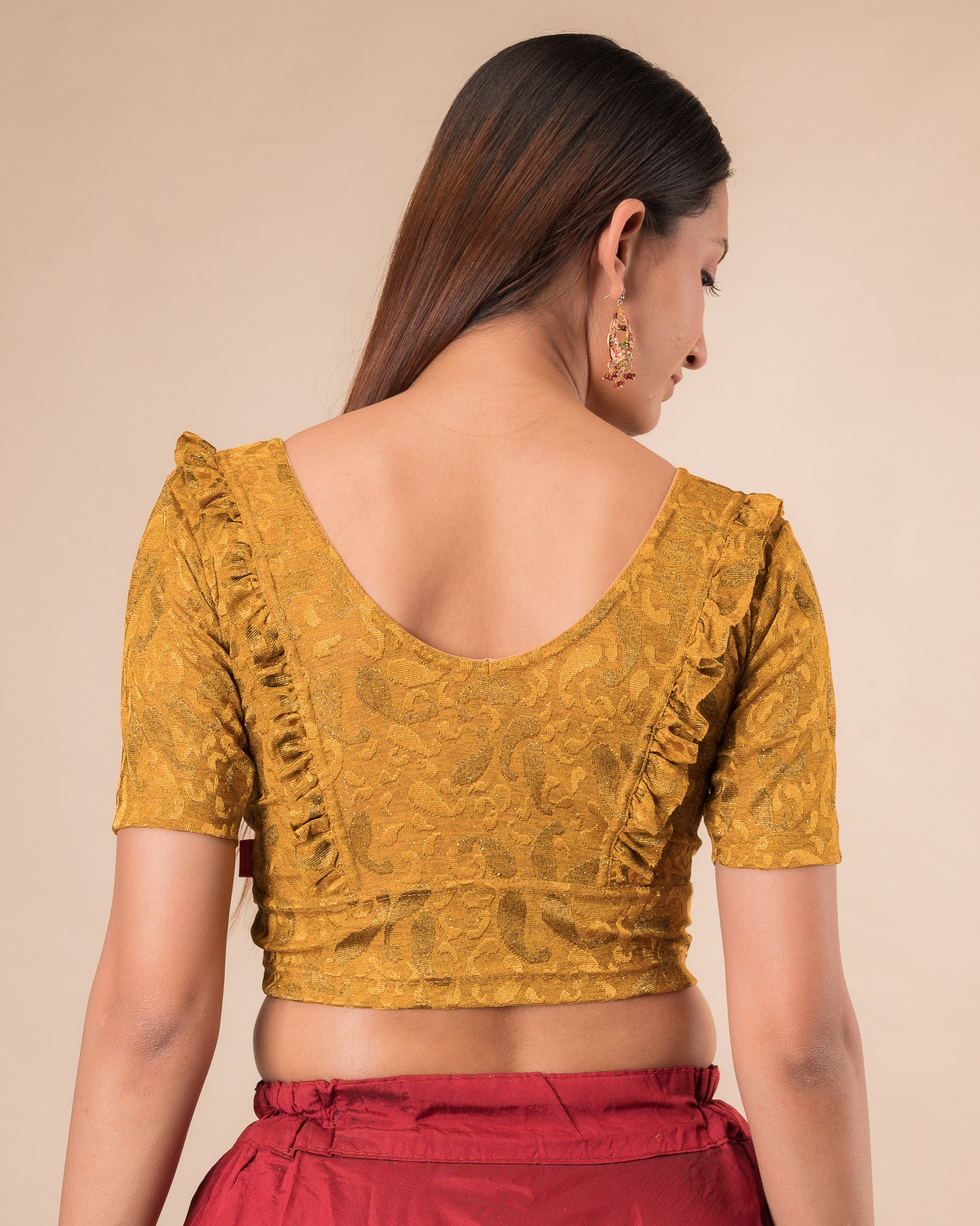 Rear view showcasing the slip-on design and ruffled shoulder detail