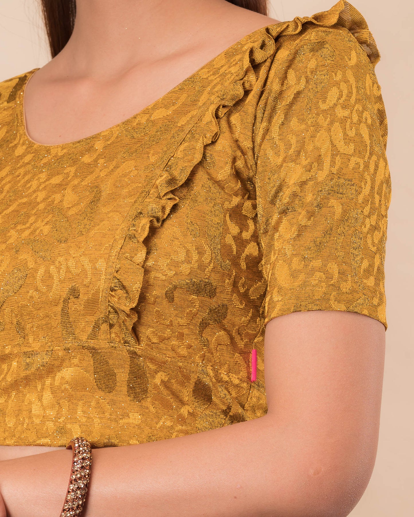 Close-up of the melange jacquard knit with subtle glitter and paisley pattern