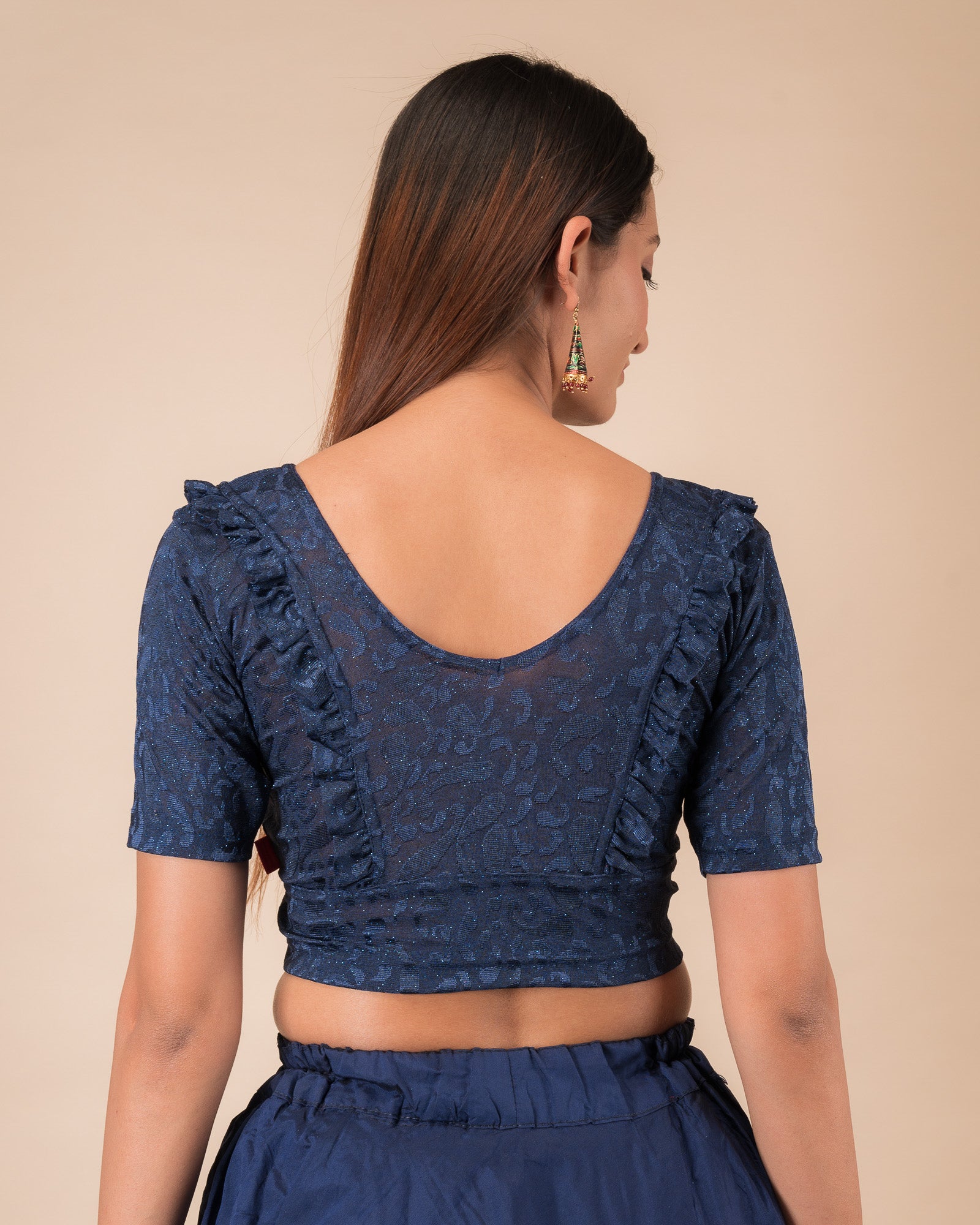 Rear view showcasing the slip-on design and ruffled shoulder detail