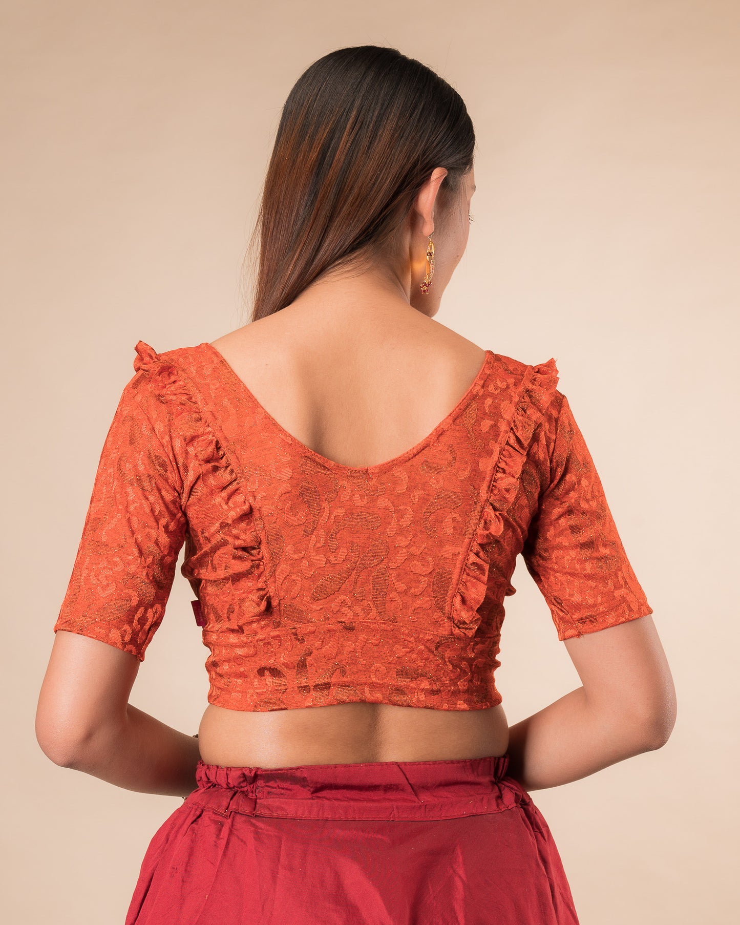 Rear view showcasing the slip-on design and ruffled shoulder detail