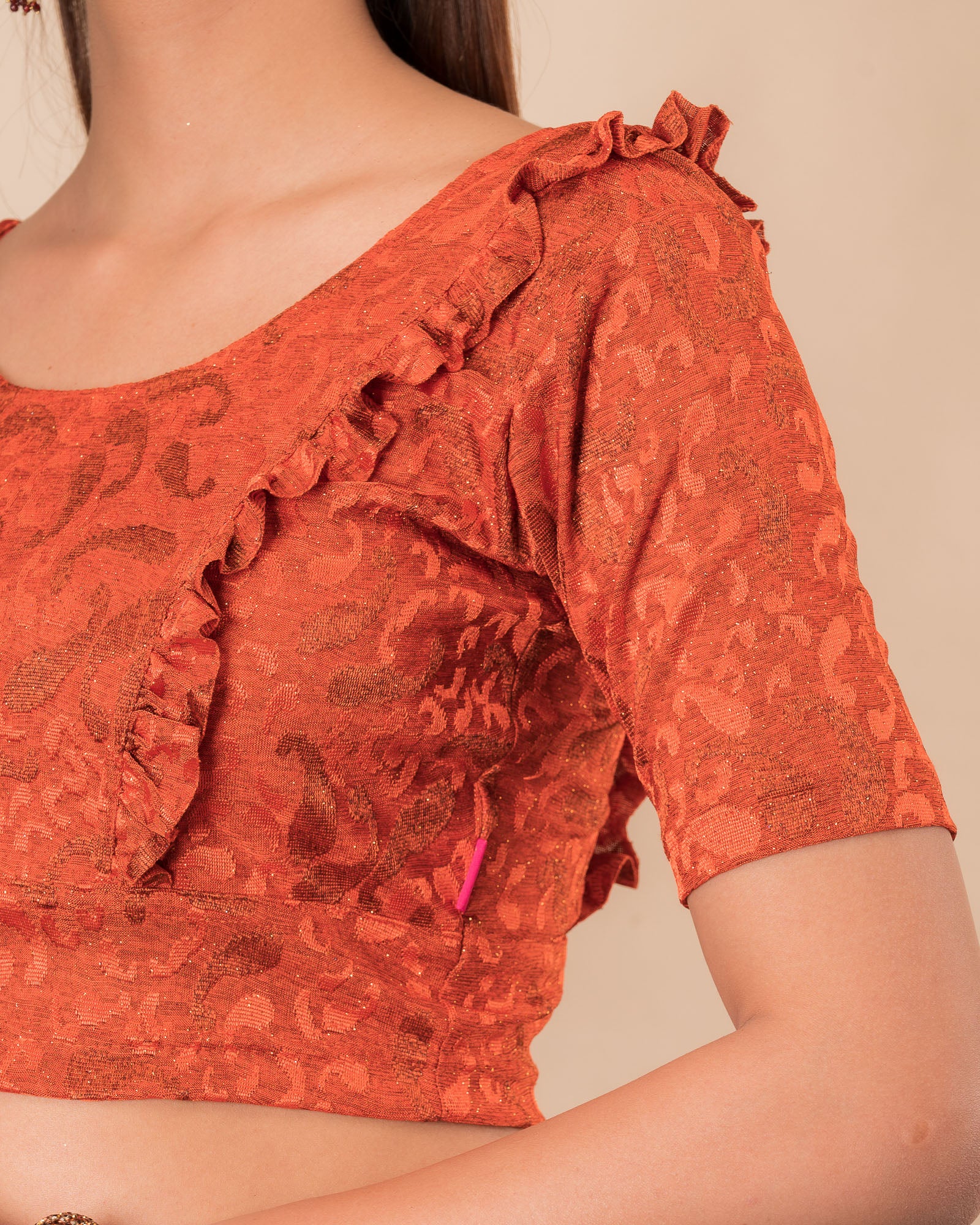 Close-up of the melange jacquard knit with subtle glitter and paisley pattern