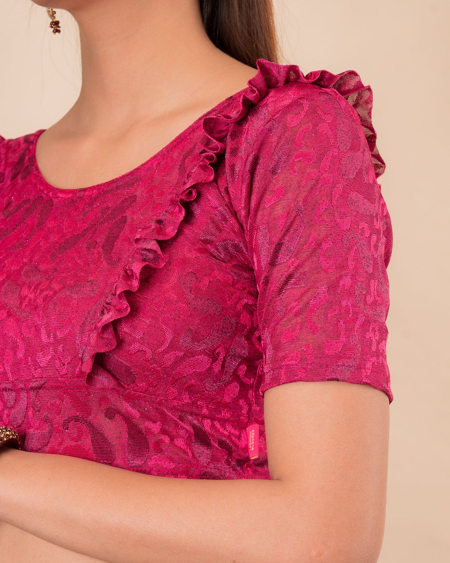 Close-up of the melange jacquard knit with subtle glitter and paisley pattern