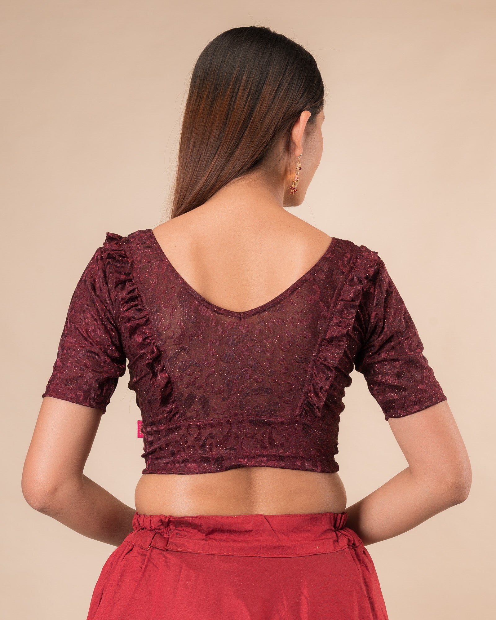 Rear view showcasing the slip-on design and ruffled shoulder detail
