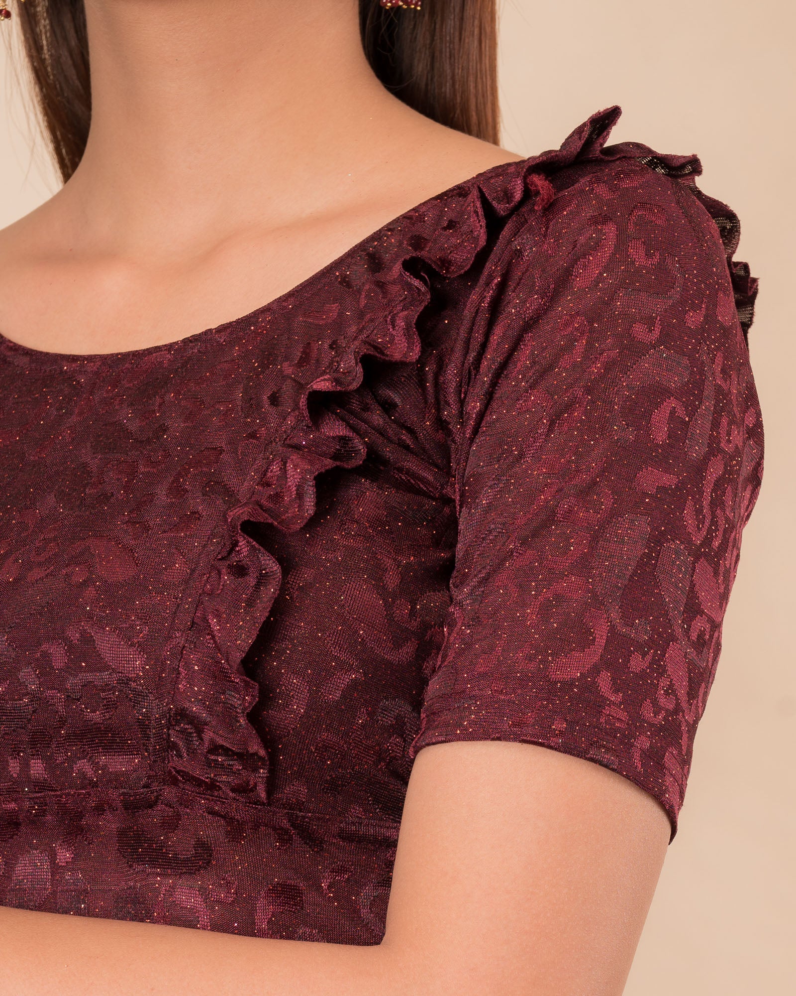 Close-up of the melange jacquard knit with subtle glitter and paisley pattern