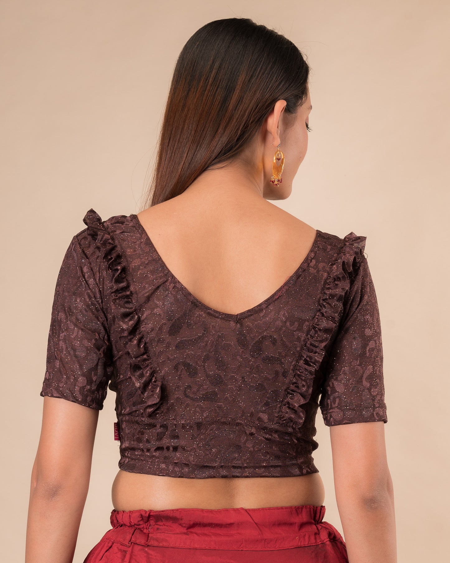 Rear view showcasing the slip-on design and ruffled shoulder detail