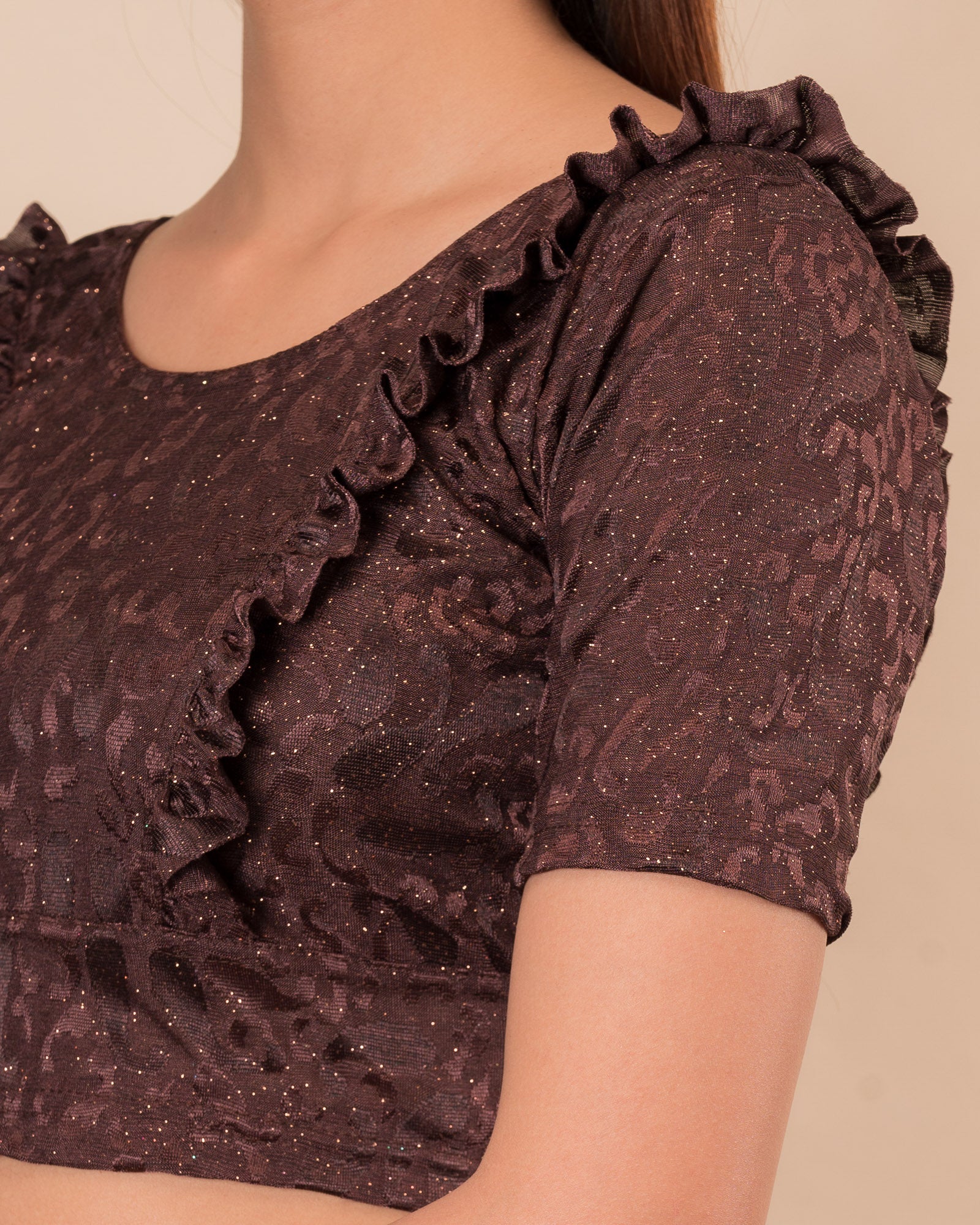 Close-up of the melange jacquard knit with subtle glitter and paisley pattern