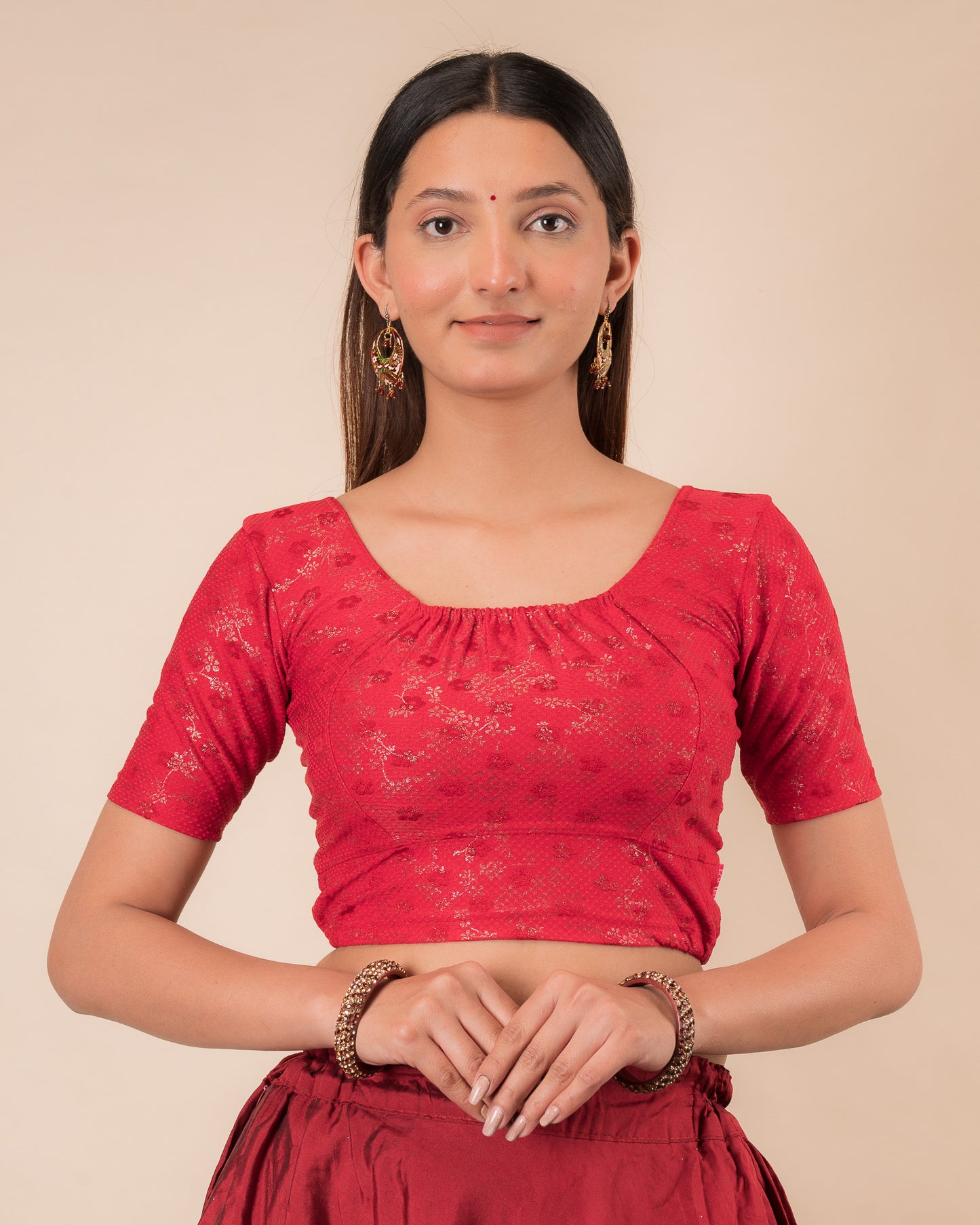 Model wearing a metallic zig-zag striped stretchable choli-style blouse with elbow sleeves and round neckline