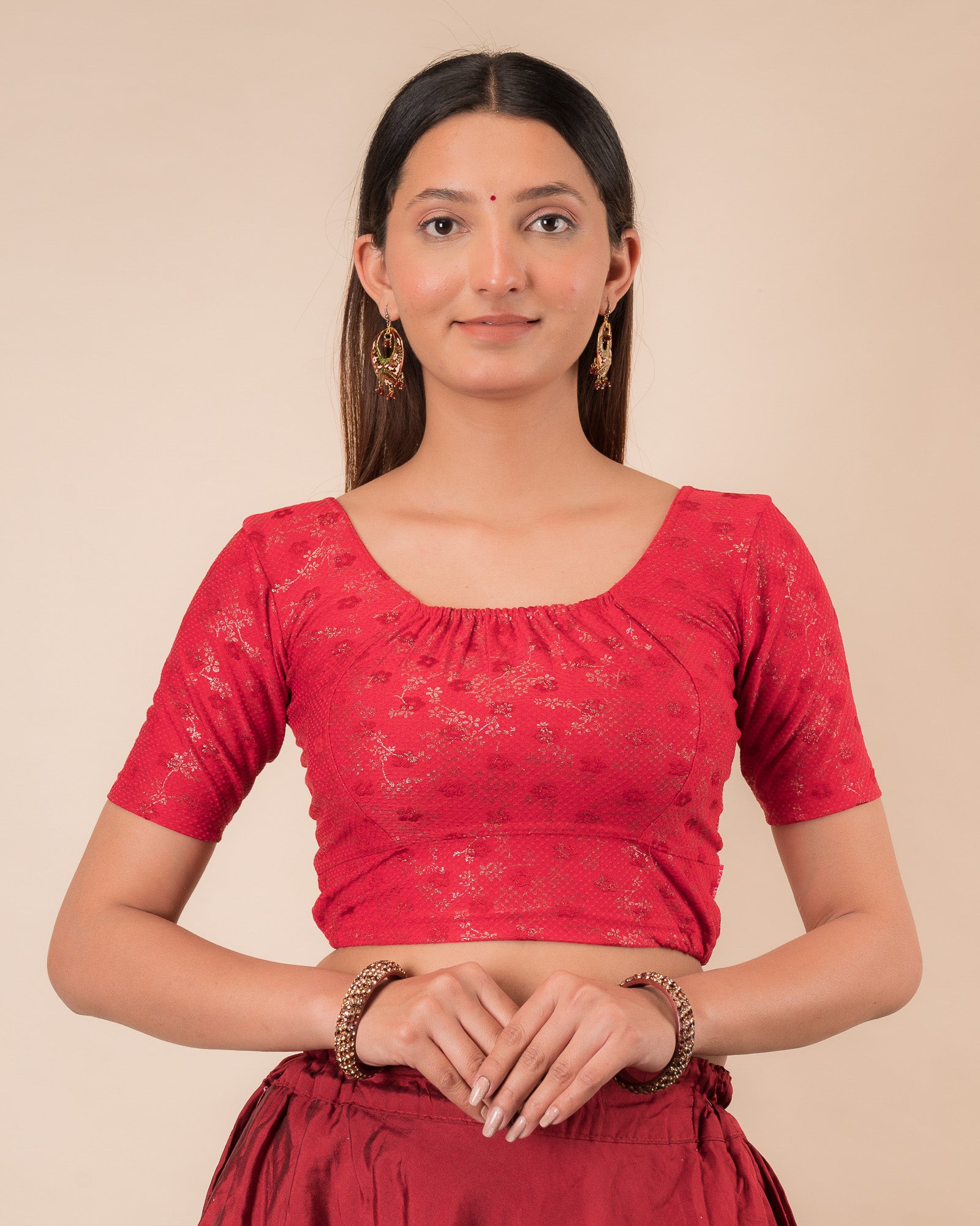 Model wearing a metallic zig-zag striped stretchable choli-style blouse with elbow sleeves and round neckline