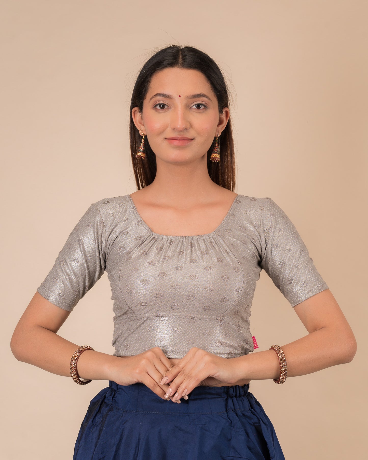 Model wearing a metallic zig-zag striped stretchable choli-style blouse with elbow sleeves and round neckline