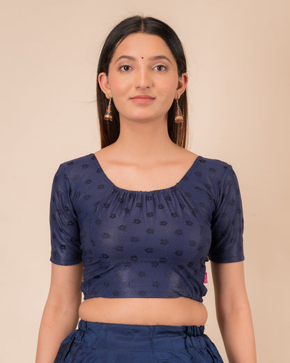 Model wearing a metallic zig-zag striped stretchable choli-style blouse with elbow sleeves and round neckline