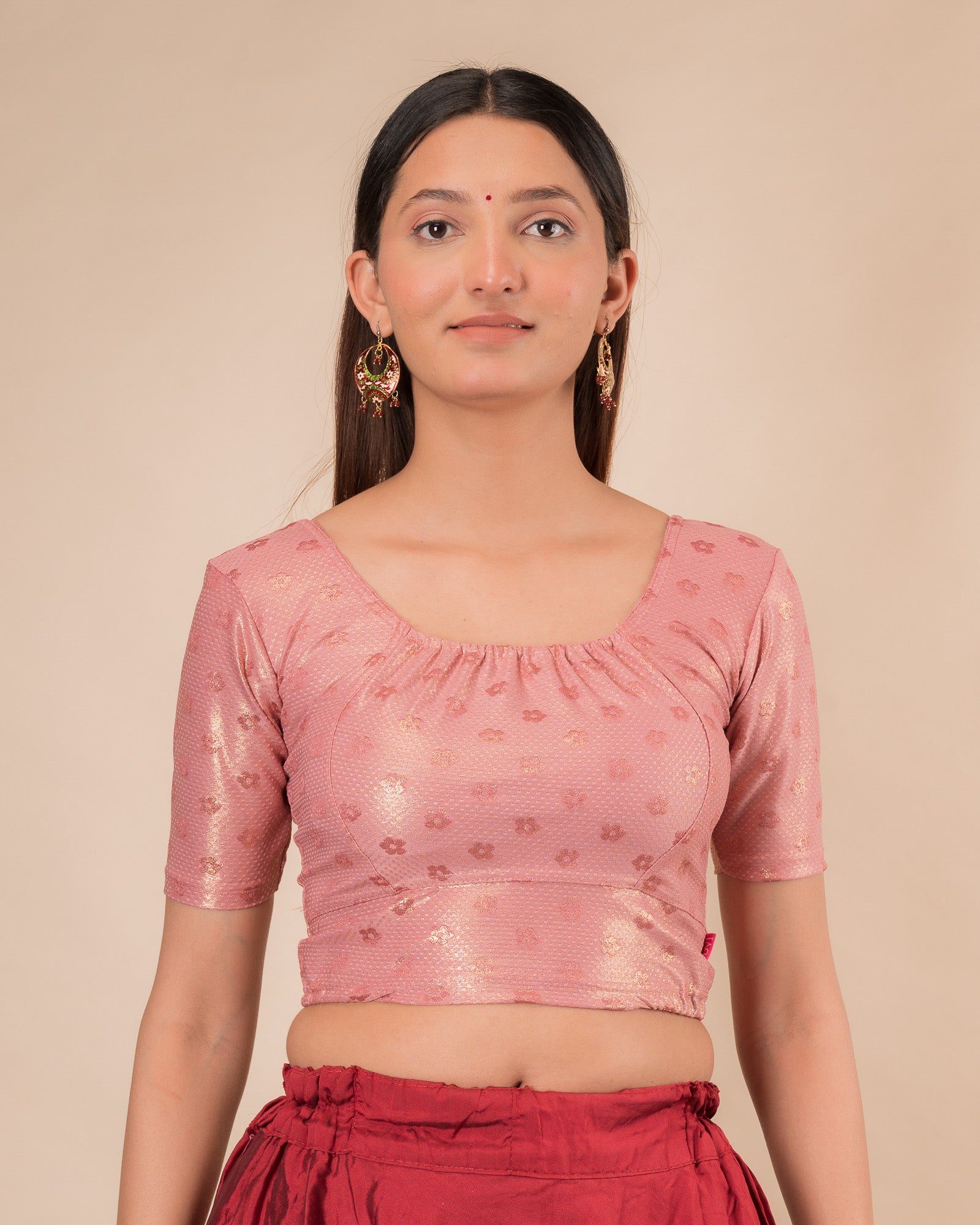 Model wearing a metallic zig-zag striped stretchable choli-style blouse with elbow sleeves and round neckline