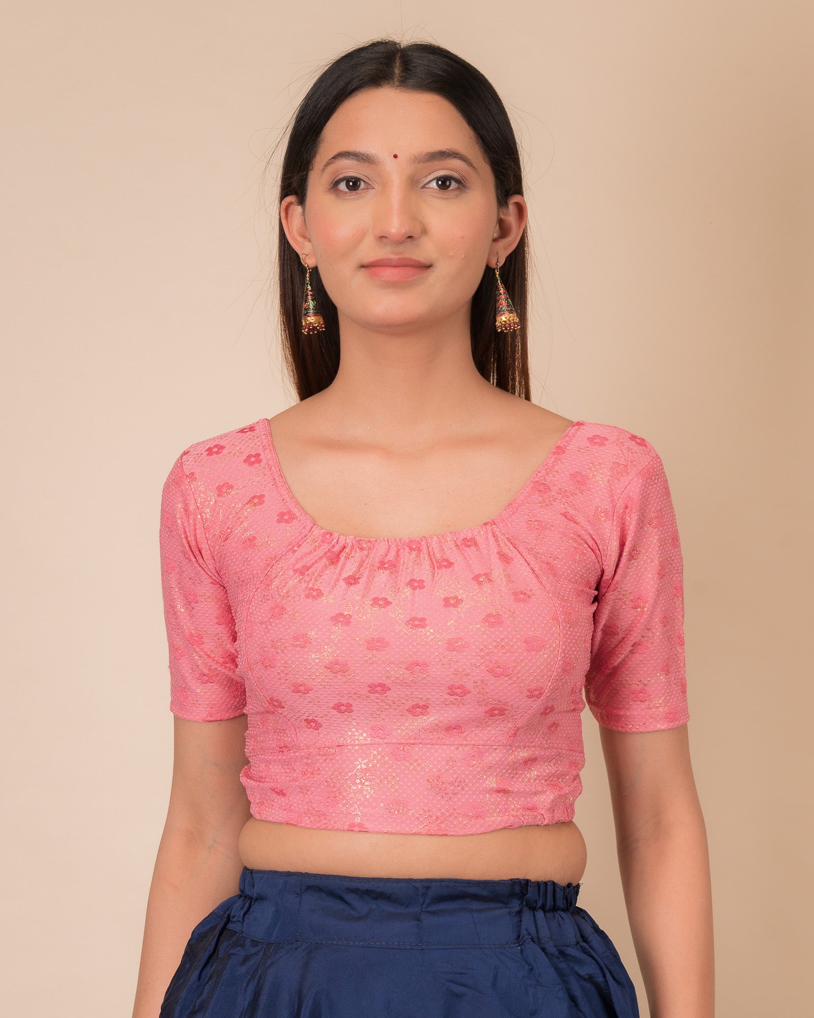 Model wearing a metallic zig-zag striped stretchable choli-style blouse with elbow sleeves and round neckline