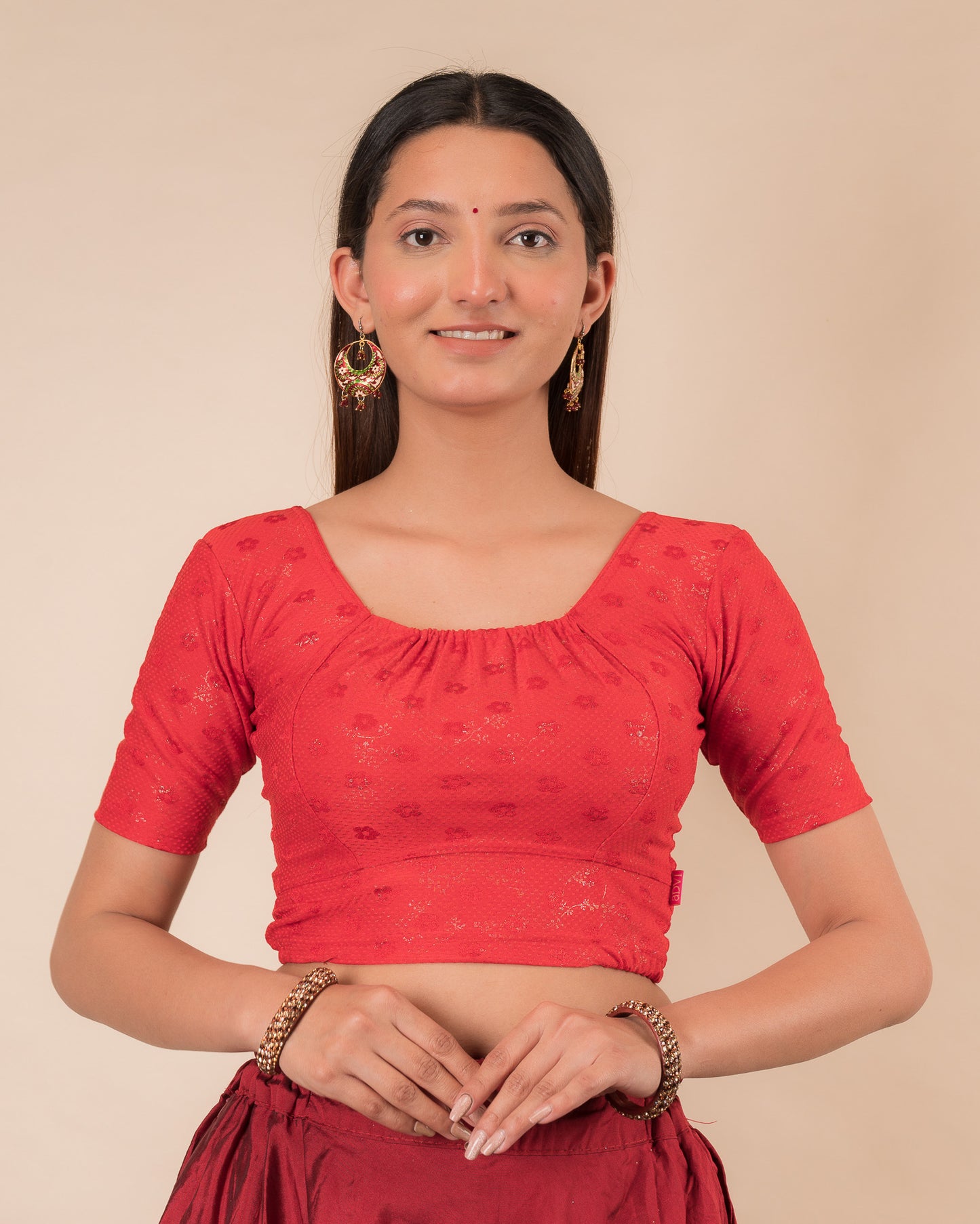 Model wearing a metallic zig-zag striped stretchable choli-style blouse with elbow sleeves and round neckline