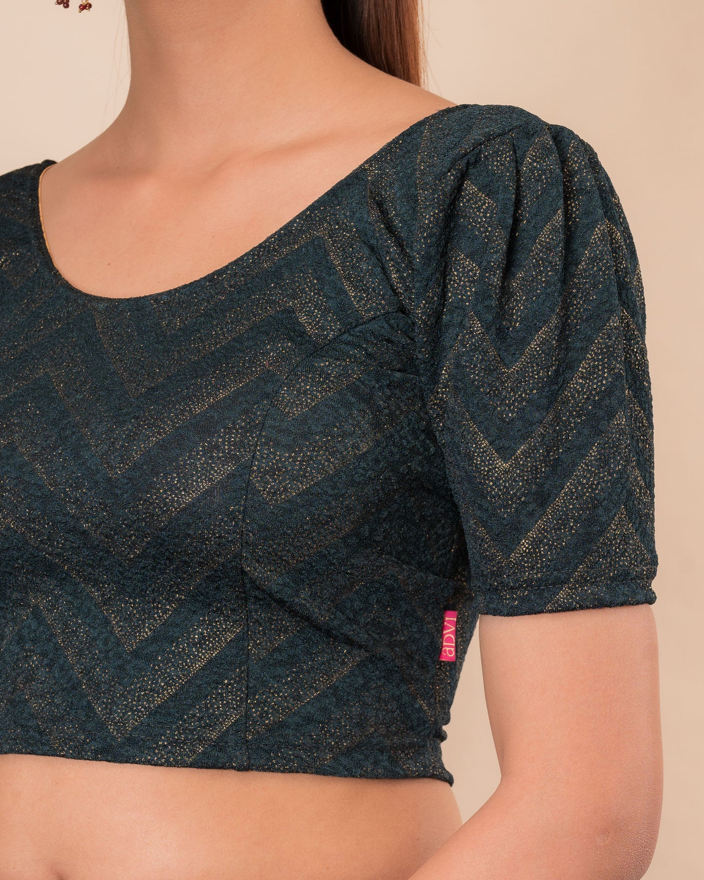 Close-up of the melange jacquard knit with subtle glitter and paisley pattern