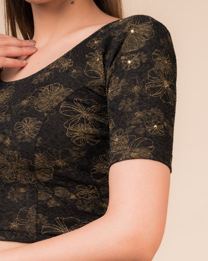 Close-up detailing the floral foil texture and stone work on jacquard fabric