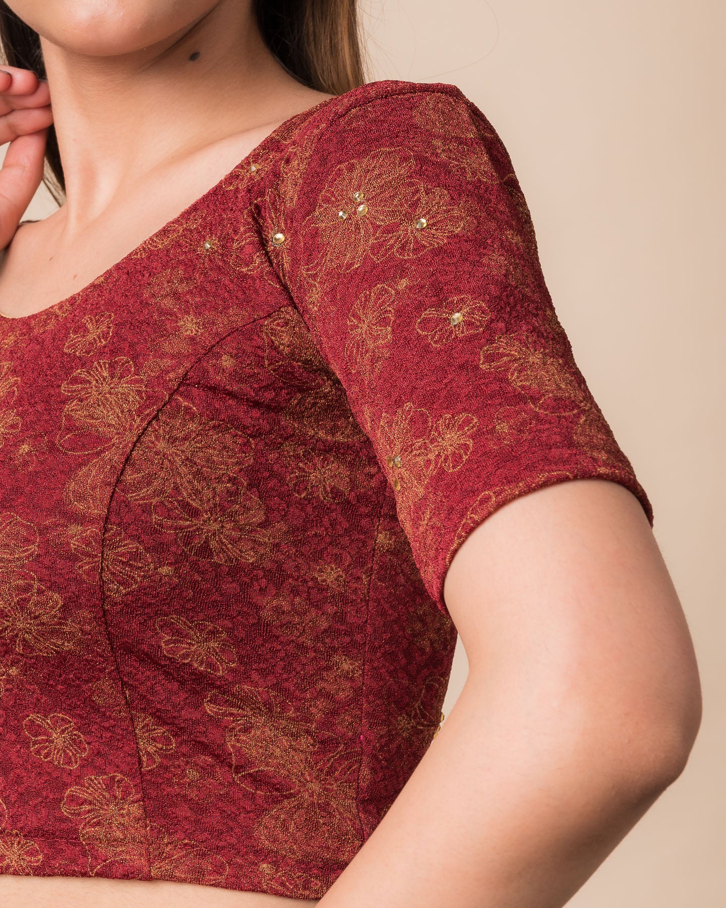Close-up detailing the floral foil texture and stone work on jacquard fabric