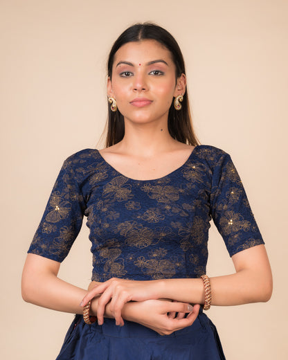 Model wearing a maroon foil and stone-embellished stretchable blouse with elbow sleeves and round neckline
