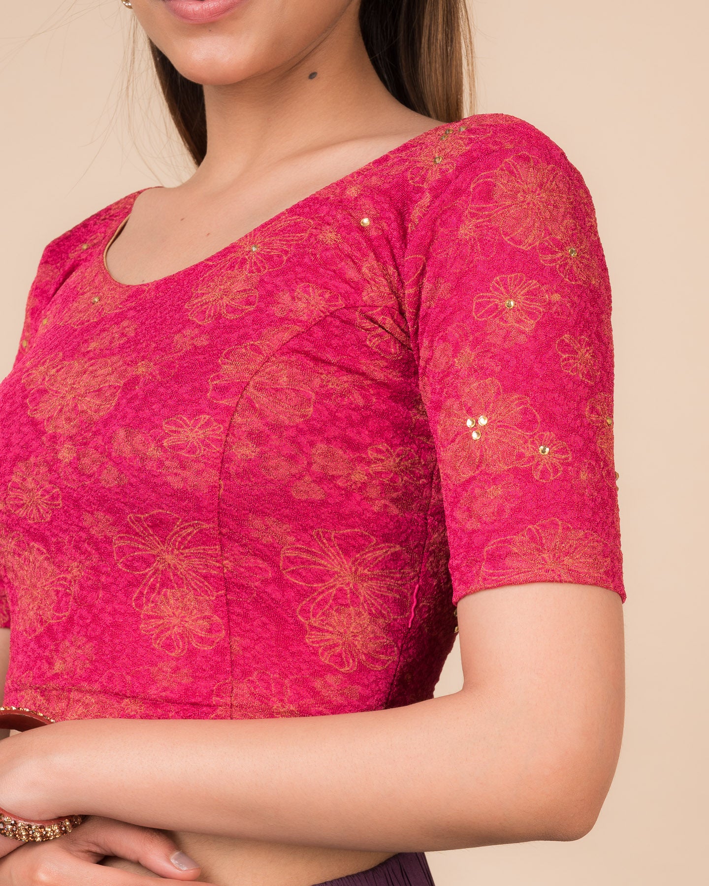 Close-up detailing the floral foil texture and stone work on jacquard fabric