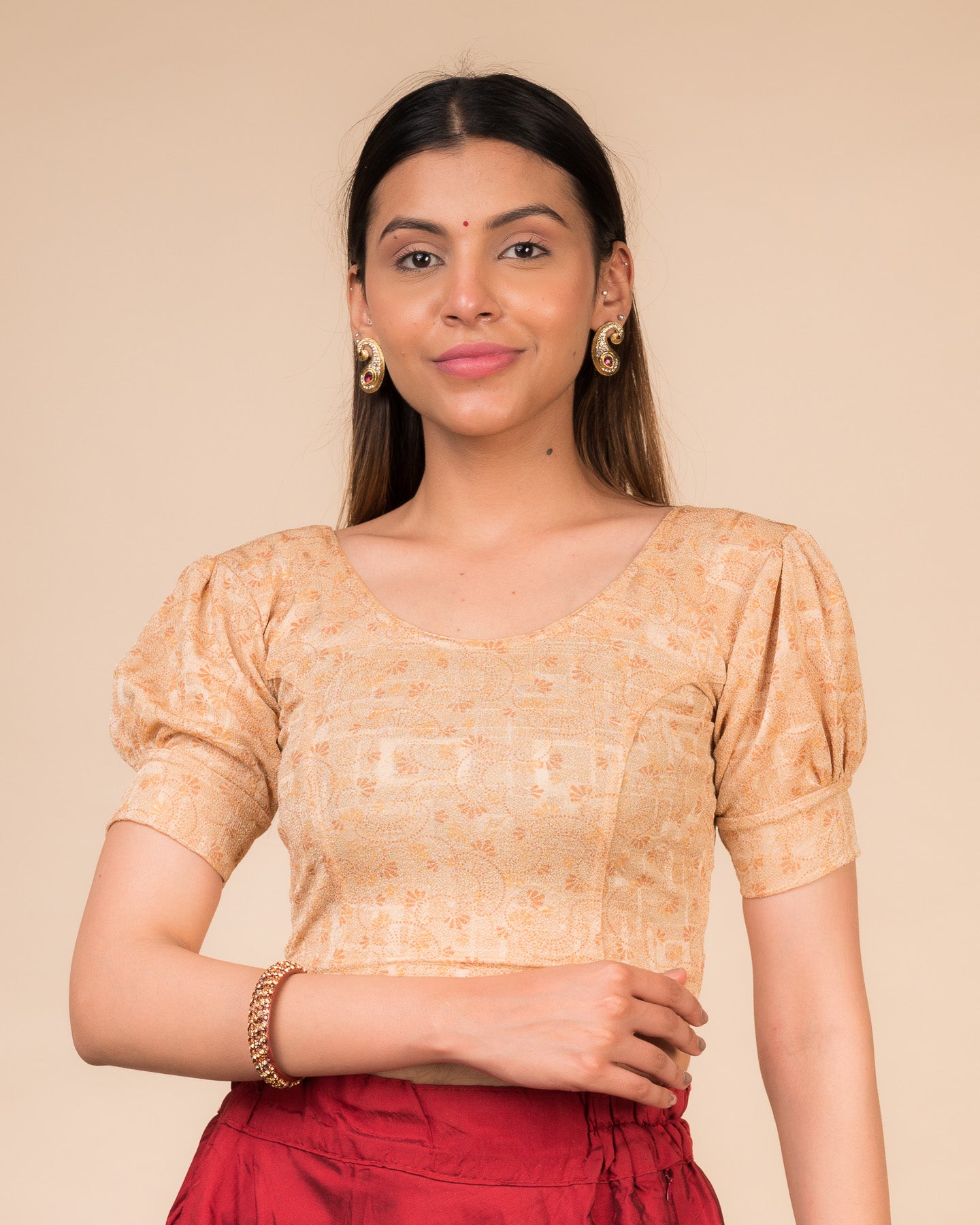 Model wearing a navy stretchable blouse with elbow sleeves, metallic print, and round neckline